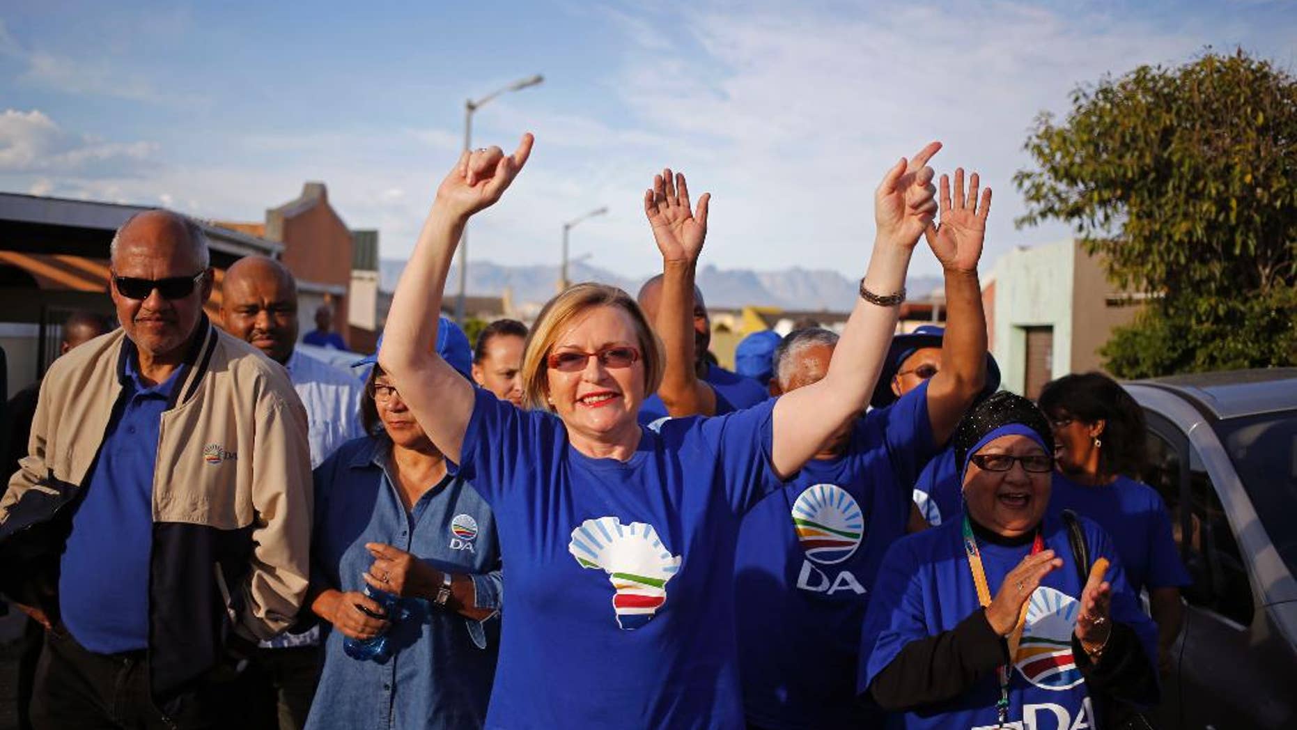 FILE-In this file photo taken on Tuesday, May 6, 2014, South African opposition leader Hellen Zille, centre, from the Democratic Alliance, participates un a party rally in Rocklands on the outskirts of Cape Town, South Africa. An article about fetal alcohol syndrome published earlier March in South Africa's Cape Times has set off a divisive debate about 'Baby Thomas' who is alleged to have been damaged by alcohol, but Hellen Zille has questioned whether the article is accurate, saying there is “no clear time frame and scant details” about a baby that allegedly was damaged in the womb by his mother’s drinking. (AP Photo/Schalk van Zuydam, FILE)