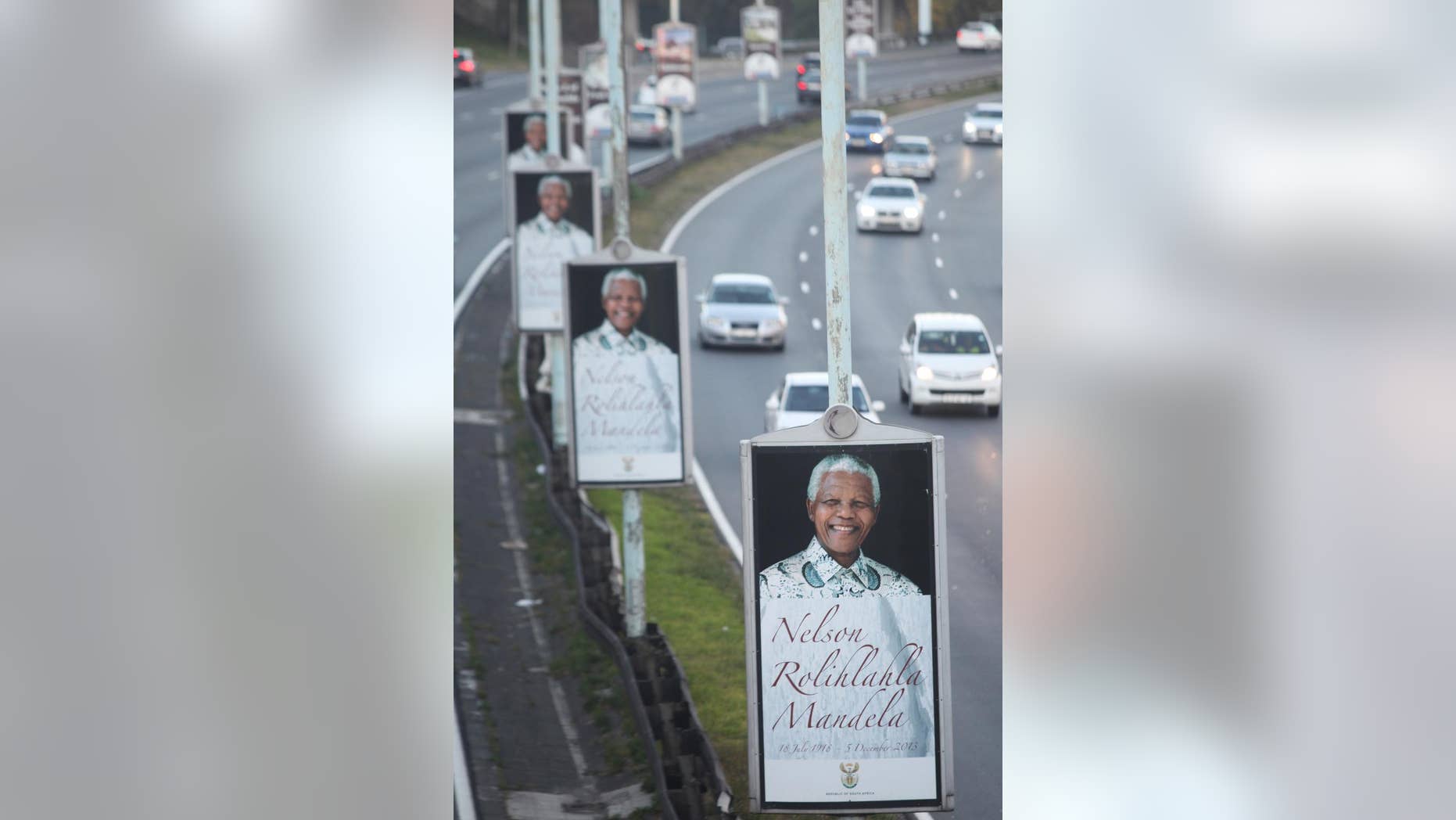 Posters depicting the late former president Nelson Mandela are lined up along a freeway in Johannesburg, Friday May 2, 2014. The country goes to the polls Wednesday May 7 as South Africa marks its 20th anniversary of democracy on Sunday. Mandela, the anti-apartheid leader became president in 1994 and died in December at the age of 95. (AP Photo/Denis Farrell)