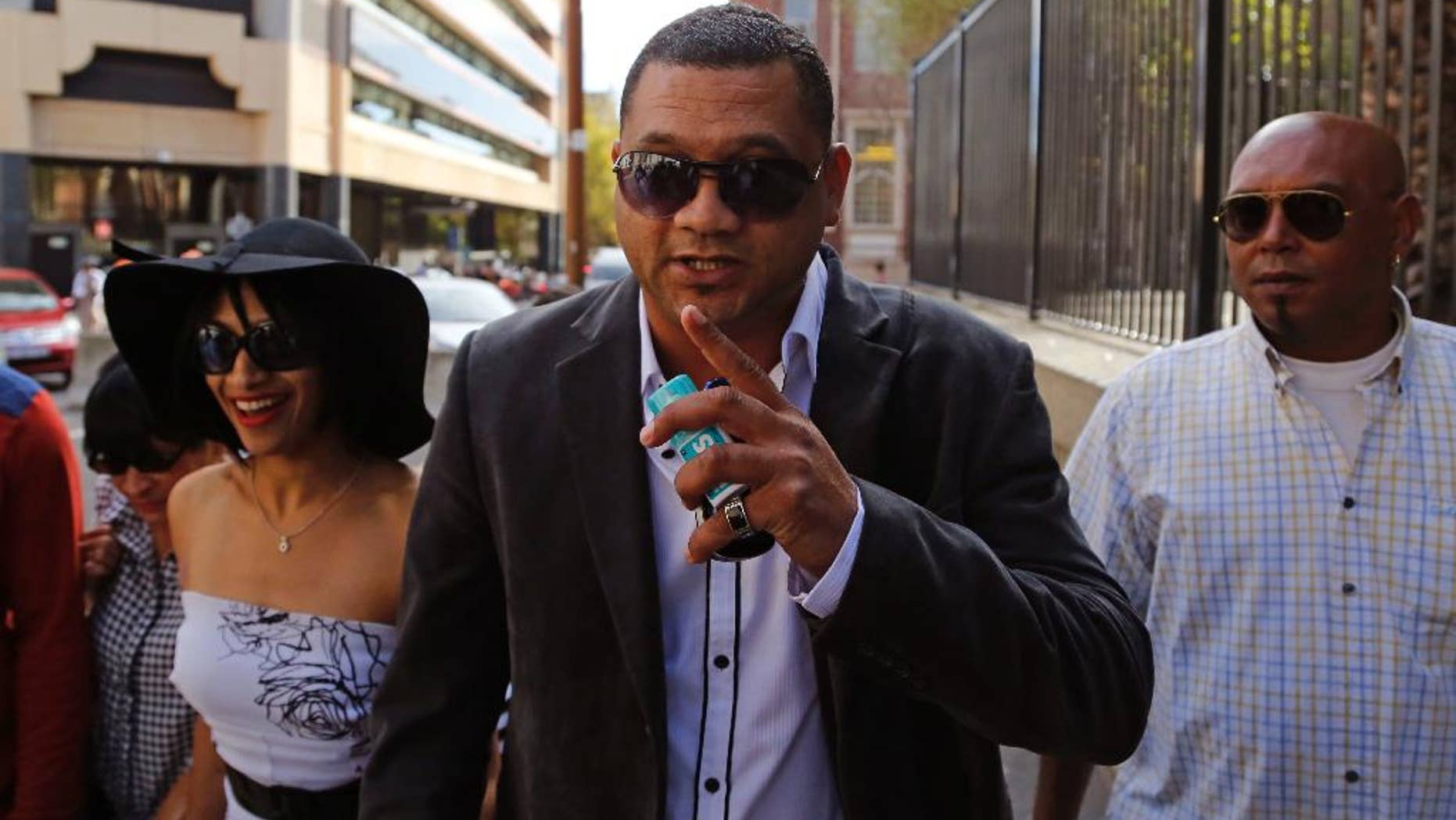 FILE - In this Friday March 6, 2015 file photo, Morne Nurse, center, the father of a girl that was kidnapped as a baby 17 years ago, and his wife Celeste Nurse, left, arrive at court for the appearance of a woman suspected of the kidnapping in Cape Town, South Africa. Morne Nurse, who was reunited with his kidnapped daughter after 17 years said on Tuesday March 10, 2015, that he would like to talk to Madeleine McCann's parents. (AP Photo/Schalk van Zuydam, File)
