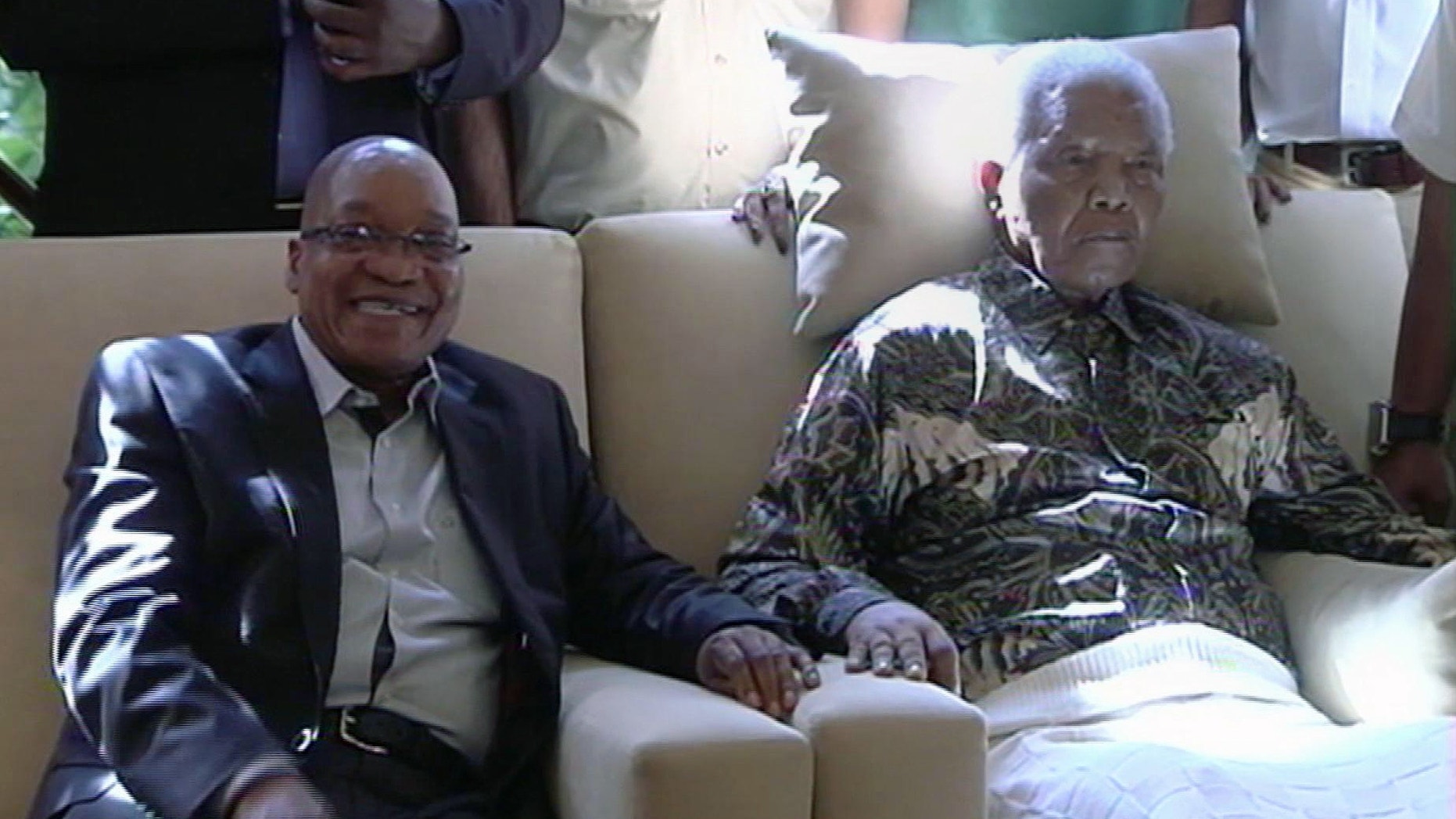 April 29, 2013 - In this image taken from video, South African President Jacob Zuma, left, sits with the ailing anti-apartheid icon Nelson Mandela.