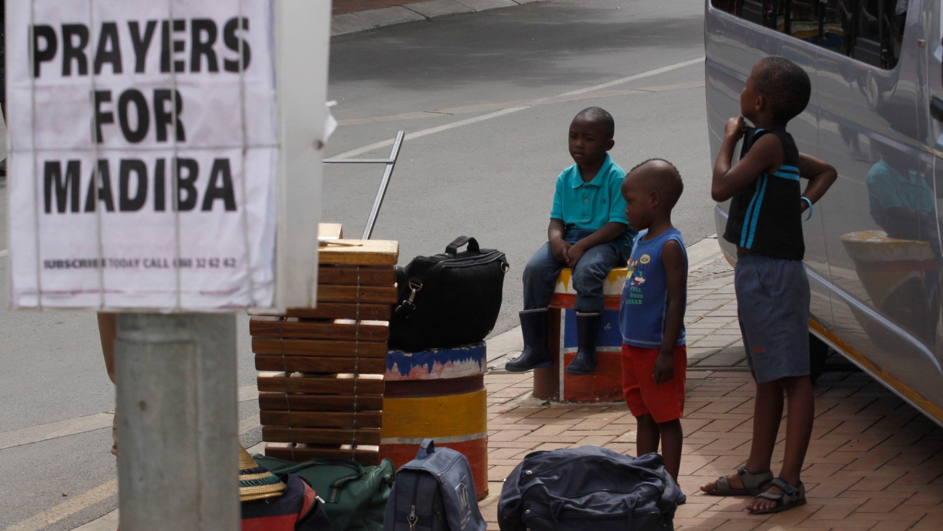 Dec 10, 2012 - Children hang out next to newspaper headline in tourist hub of Soweto South Africa, where Nelson Mandela once lived. Mandela is affectionately known as Madiba.