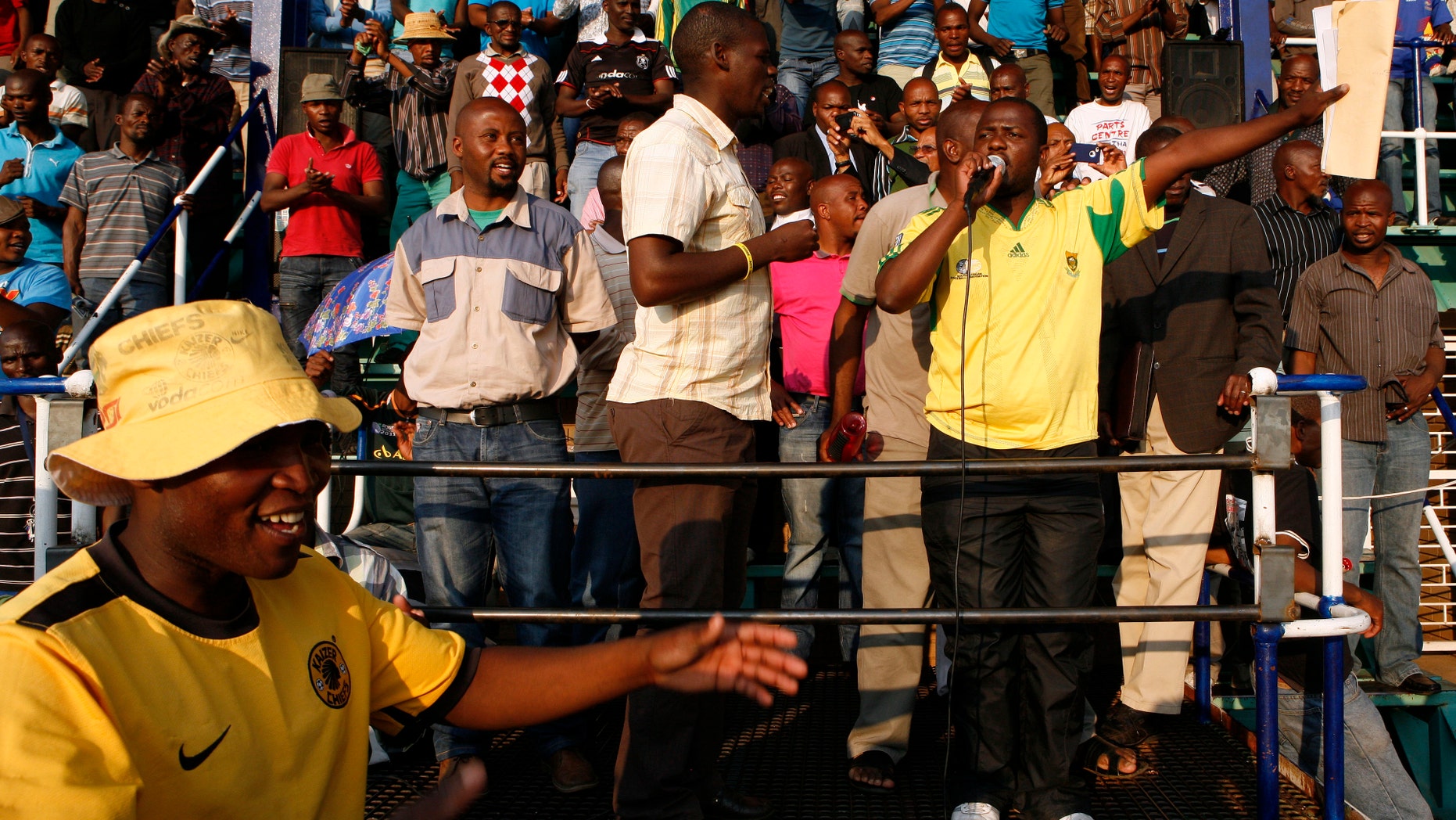 Miners sing and dance in Lonmin Platinum Mine near Rustenburg, South Africa, Tuesday, Sept. 18, 2012. Striking miners have accepted a company offer of a 22% overall pay increase to end more than five weeks of crippling and bloody industrial action. (AP Photo/Themba Hadebe)