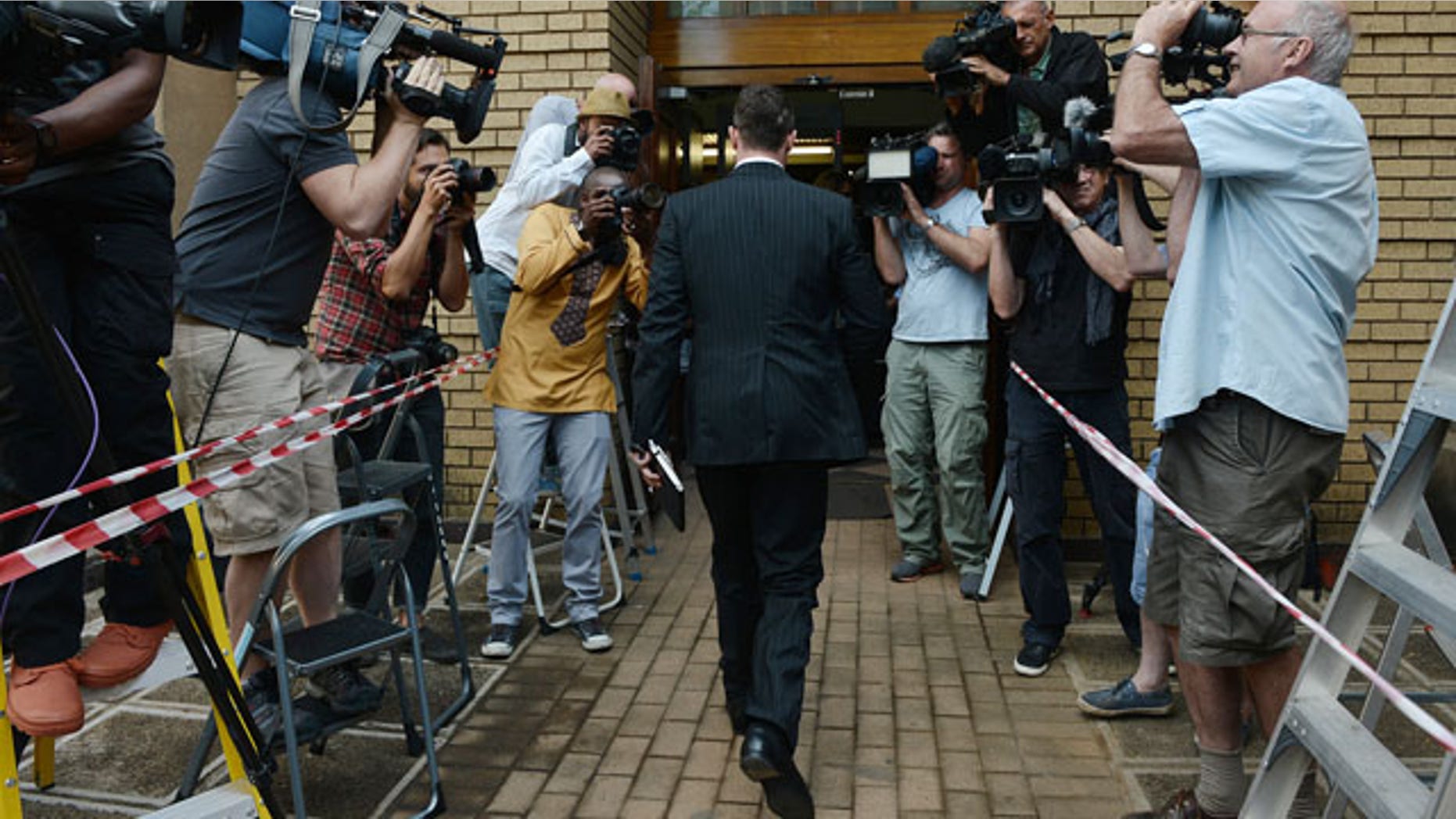 October 14, 2014: Oscar Pistorius enters court to face day two of sentencing processes for the shooting death of his girlfriend Reeva Steenkamp. Pistorius was found guilty last month on a culpable homicide charge. (AP Photo)