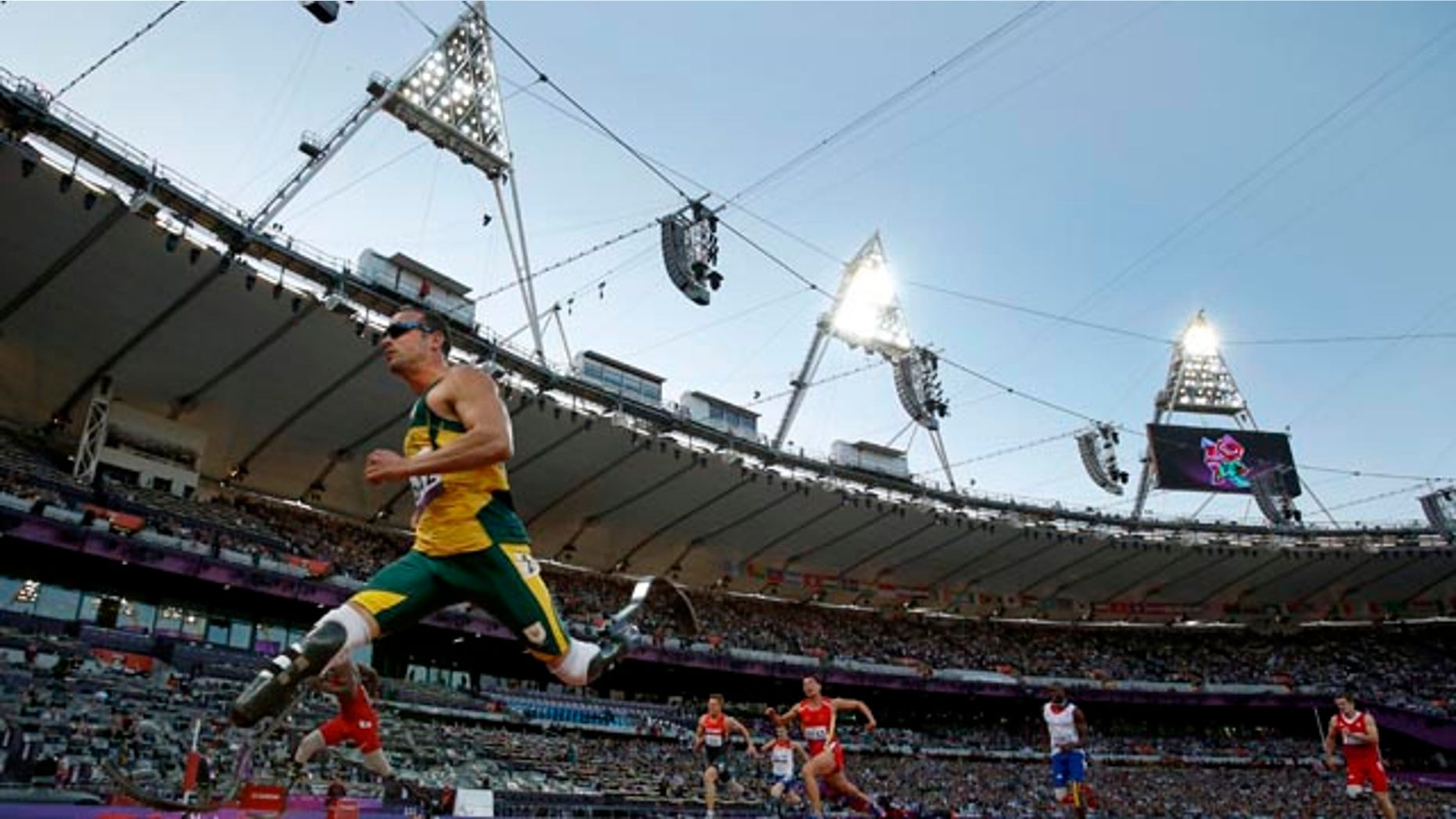 FILE - In this Wednesday, Sept. 5, 2012 file photo South Africa's Oscar Pistorius, left, crosses the line to win his men's 100m T44 category heat during the athletics competition at the 2012 Paralympics in London. (AP Photo/Matt Dunham, File)