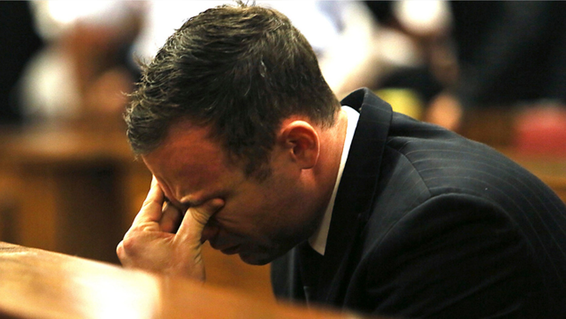 FILE - In this Friday, Sept. 12, 2015 file photo, Oscar Pistorius puts his hand on his face in court in Pretoria, South Africa, as judgement is passed in the shooting death of his girlfriend, Reeva Steenkamp. (AP Photo/Alon Skuy, Pool, File)