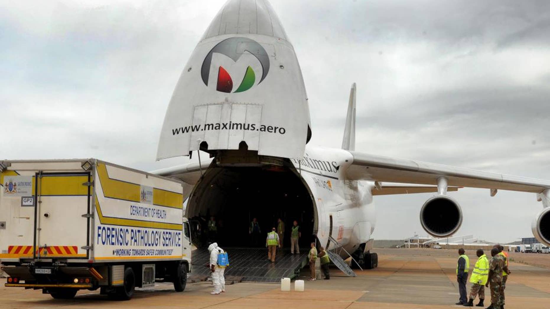 In this hand photo supplied by the government's Department's of Communications (DoC) one of four Forensic Pathology Services truck carrying the remains of some of the victims of the Nigeria building collapse, exits a chartered plane on it's arrival from Nigeria, in Pretoria, South Africa, at the Waterkloof Air Force base Sunday, Nov. 16, 2014. The remains of 74 South Africans who died in he building collapse on Sept. 12, 2014 arrived back in South Africa ahead of a ceremony at which the names of the dead were read to mourners. (AP Photo/Department of Communications) NO ARCHIVE