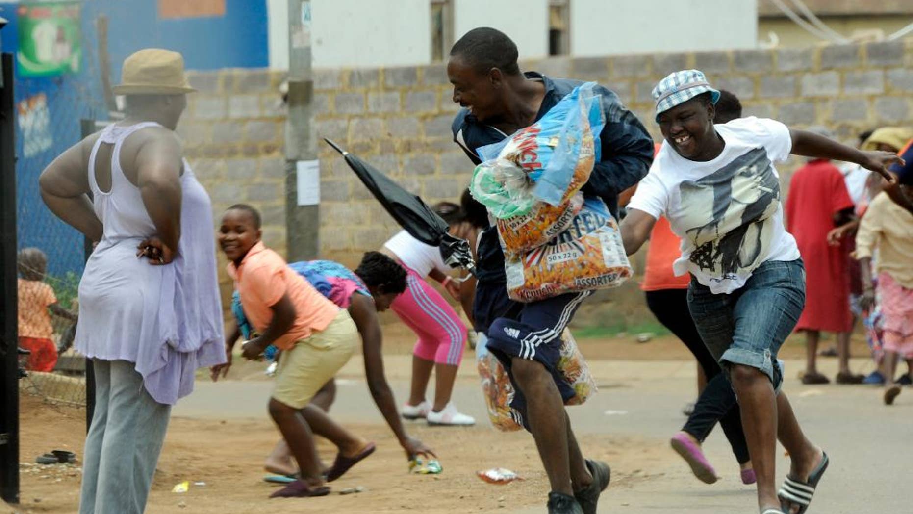 Looters make off with goods from a store in Soweto, South Africa, Thursday, Jan 22, 2015. About 70 people in South Africa have been arrested because of violent protests and looting, much of which was aimed at shops owned by nationals from other African countries, local media reported Thursday. (AP Photo) SOUTH AFRICA OUT NO SALES NO ARCHIVES