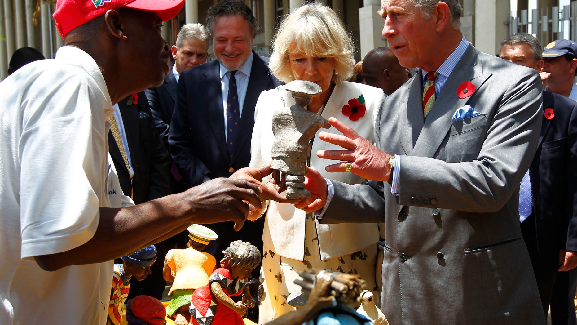 Nov. 3, 2011: Britain's Prince Charles and his wife Camilla, Duchess of Cornwall, look at local crafts during their visit to Soweto, South Africa.