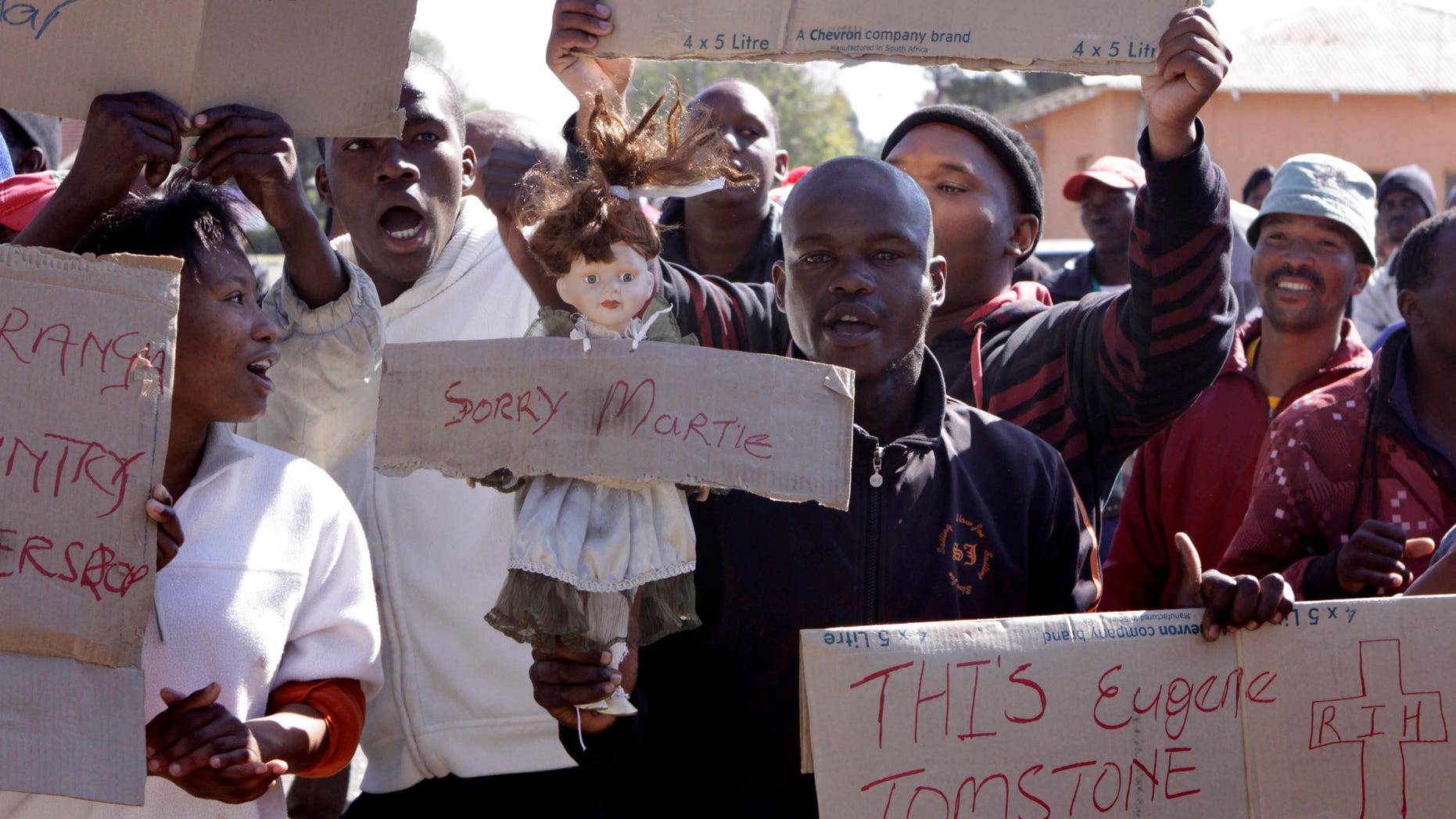 May 22, 2012: Protesters demonstrate outside the court in Ventersdorp, South Africa, as they await the verdict in the murder case of two laborers accused of killing Afrikaner Resistance Movement leader Eugene TerreBlanche.