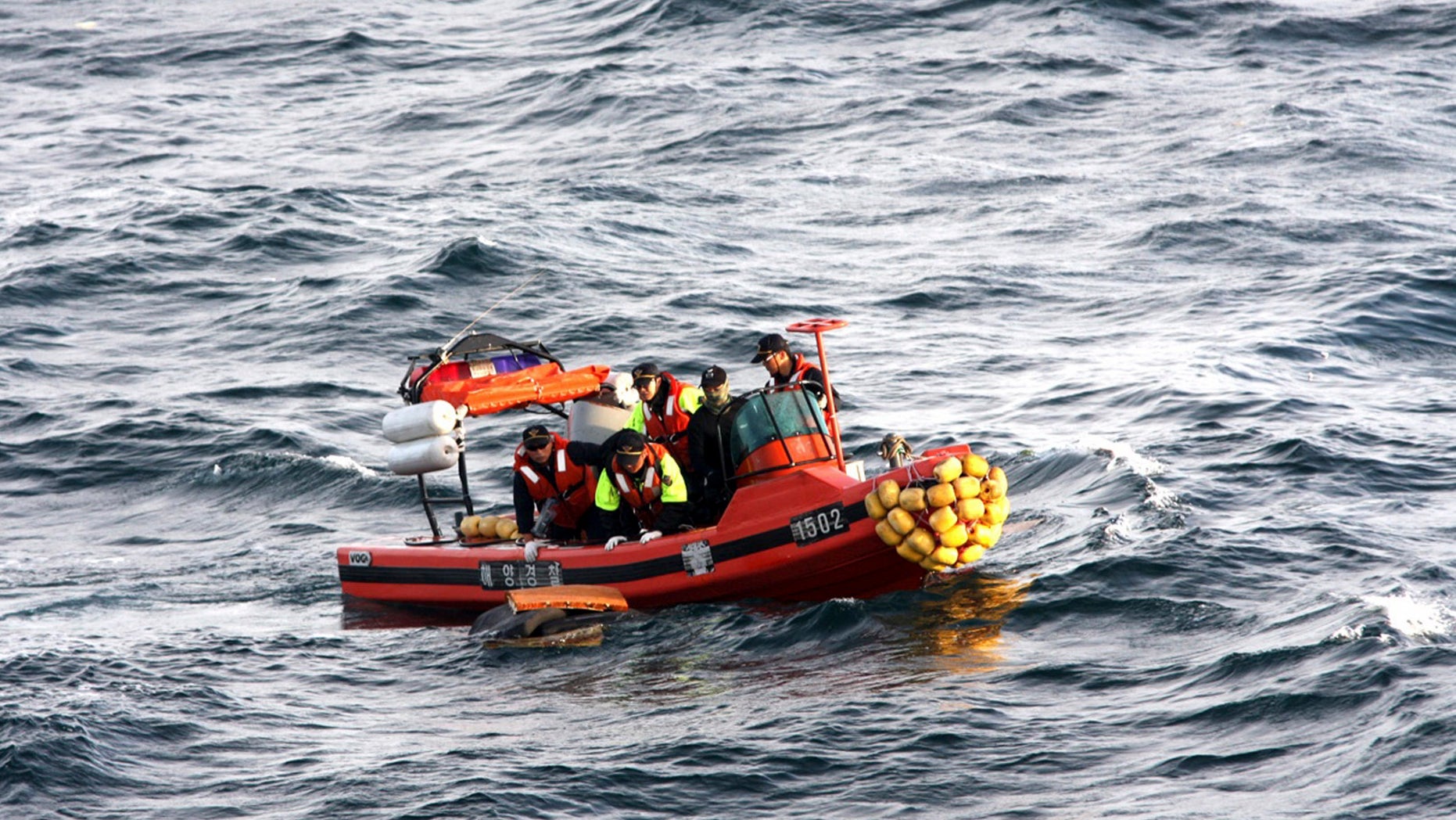 July 28: Members of Korea Coast Guard work to lift supposed debris of an Asiana Airlines cargo plane on the sea off Jeju Island, South Korea. A pilot and co-pilot died after the Asiana Airlines cargo plane crashed in the sea off South Korea's Jeju Island, the Coast Guard told Yonhap News Agency.