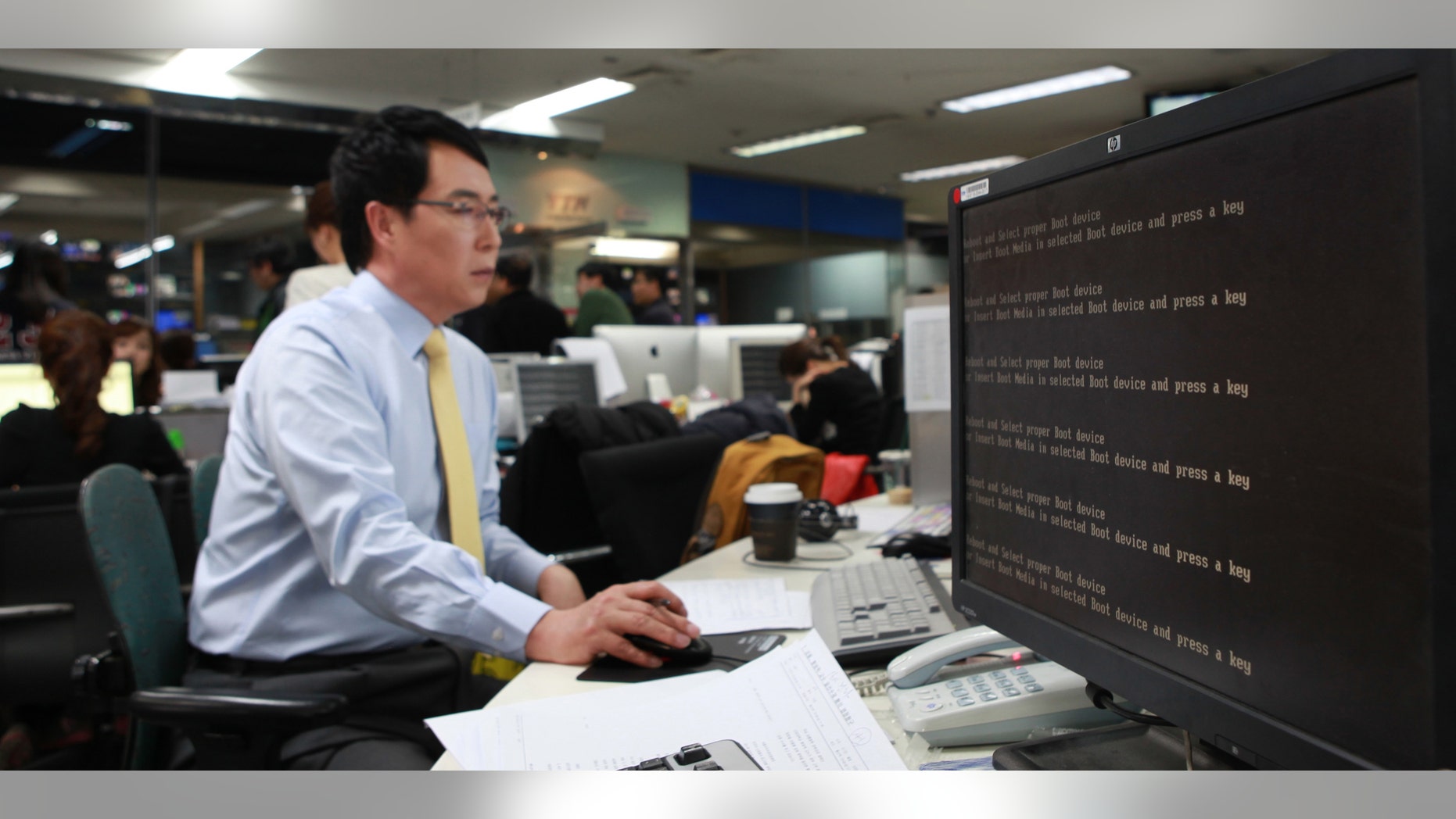 March 20, 2013: An employee works near a computer screen with error message at the newsroom of the all-news cable channel YTN as the broadcaster's computer network was paralyzed in Seoul, South Korea.