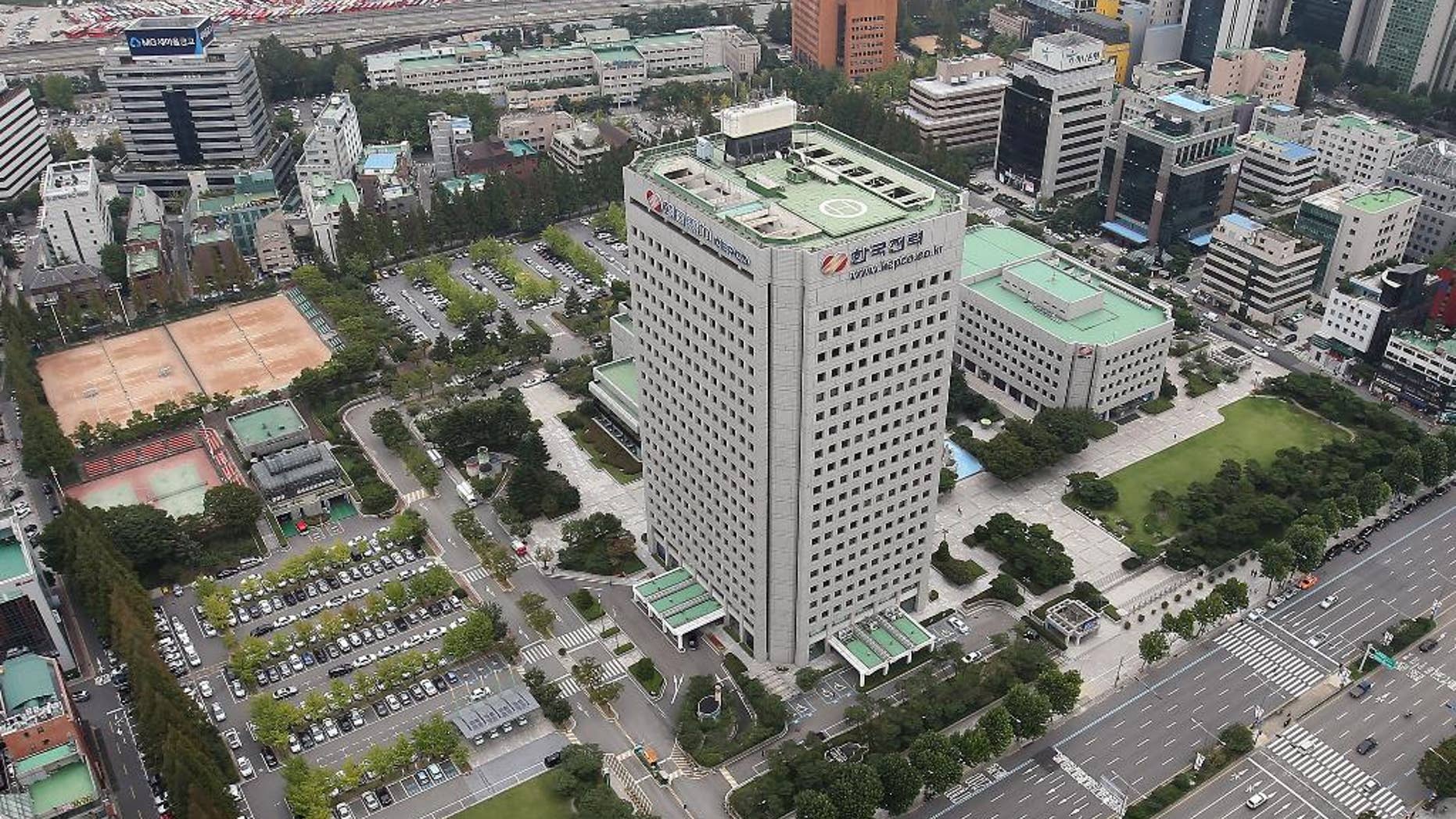 This Sept. 17, 2014 photo, shows Korea Electric Power Corp's headquarters, center, in Seoul, South Korea. The consortium led by Hyundai Motor Co. offered 10.55 trillion won ($10.1 billion) for land in Seoul's tony Gangnam district where it will build a new headquarters, on Thursday, Sept. 18, 2014. (AP Photo/Yonhap, Han Jong-chan) KOREA OUT