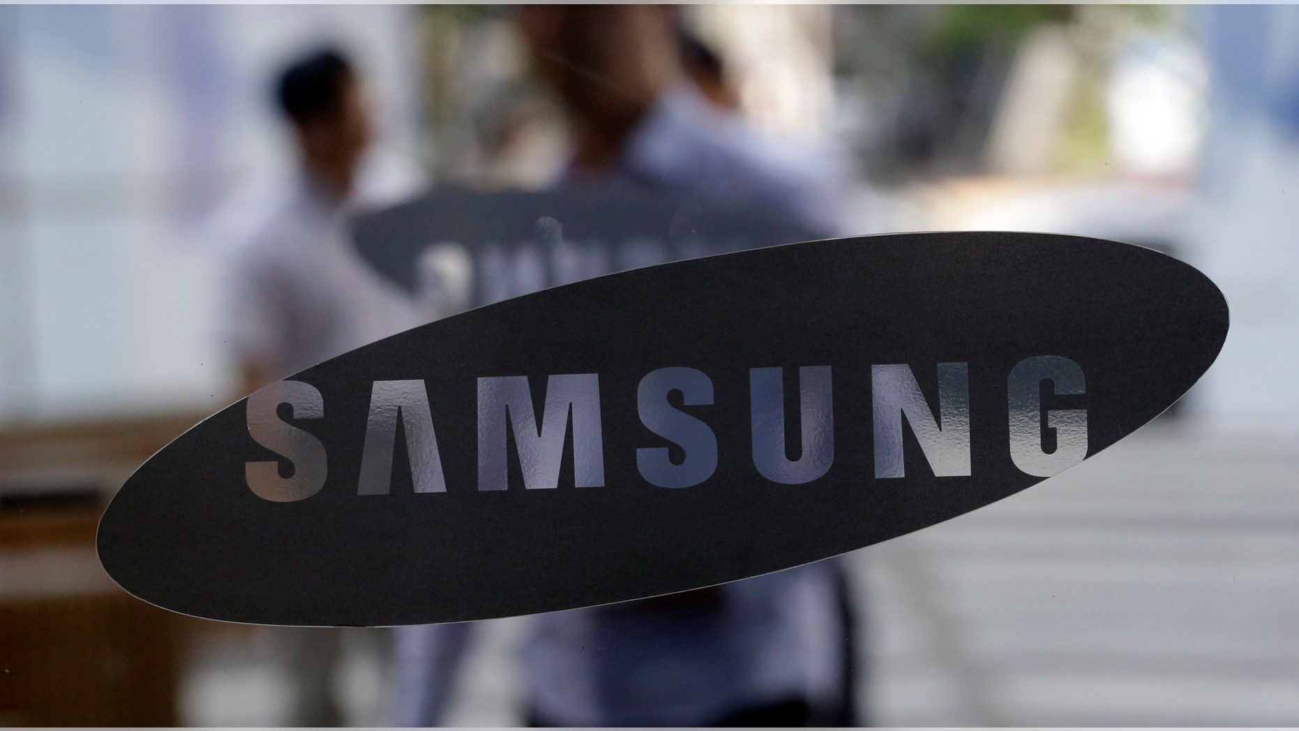 File photo - Aug. 31, 2012: People walk by the entrance to the Samsung Electronics Co. showroom at its headquarters in Seoul, South Korea. (AP)