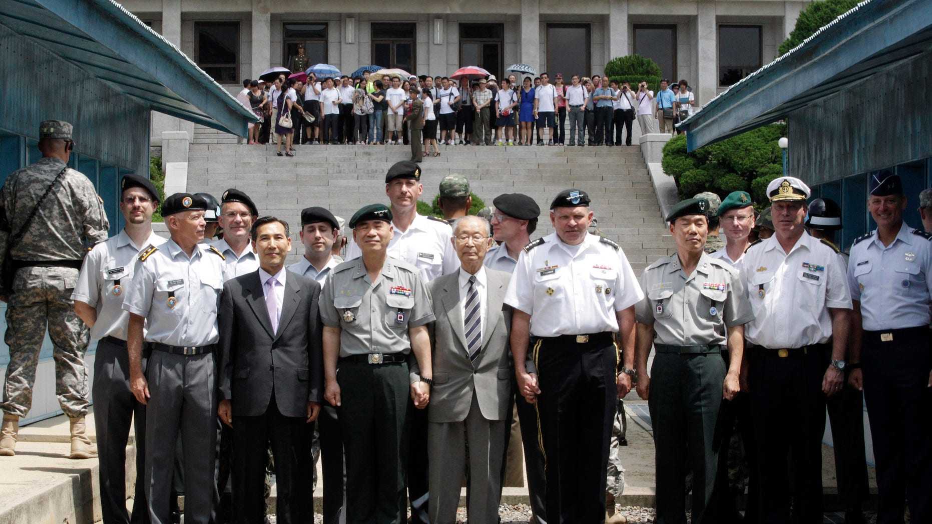 U.S. Gen. James D. Thurman, the commander of U.S. Forces Korea, fourth from right, poses with Neutral Nations Supervisory Commission, United Nations Forces and South Korean officers after a ceremony marking the 59th anniversary of the signing of the armistice agreement that ended the Korean War on July 27, 1953, at the border villages of Panmunjom, South Korea, Friday, July 27, 2012. (AP Photo/Ahn Young-joon. Pool)