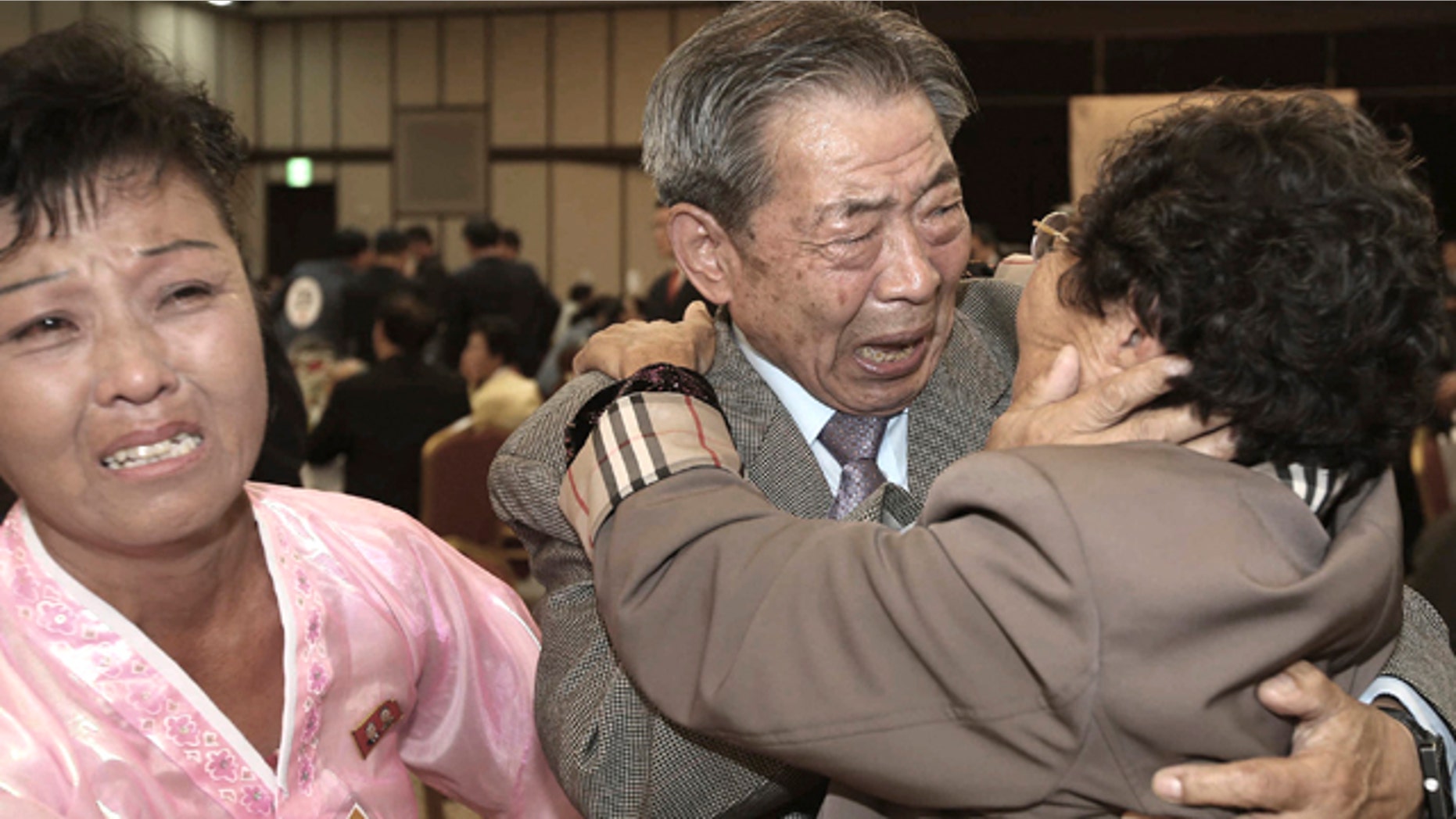 Oct. 20, 2015: South Korean Min Ho-shik, 84, center, hugs his North Korean family member Min Un Sik, right, during the Separated Family Reunion Meeting at Diamond Mountain resort in North Korea. (Kim Do-hoon/Yonhap via AP)