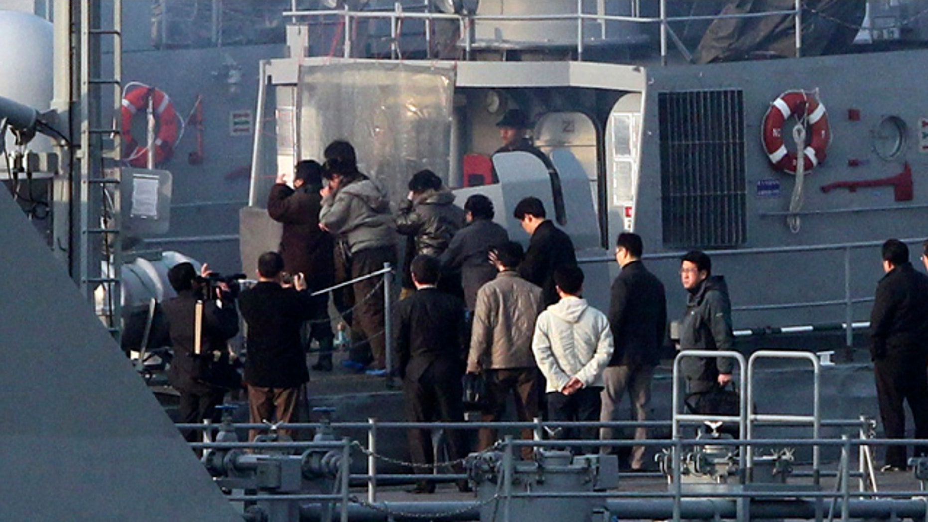 March 27, 2011: North Koreans board a South Korean navy ship to return the North at a port in Incheon, South Korea.