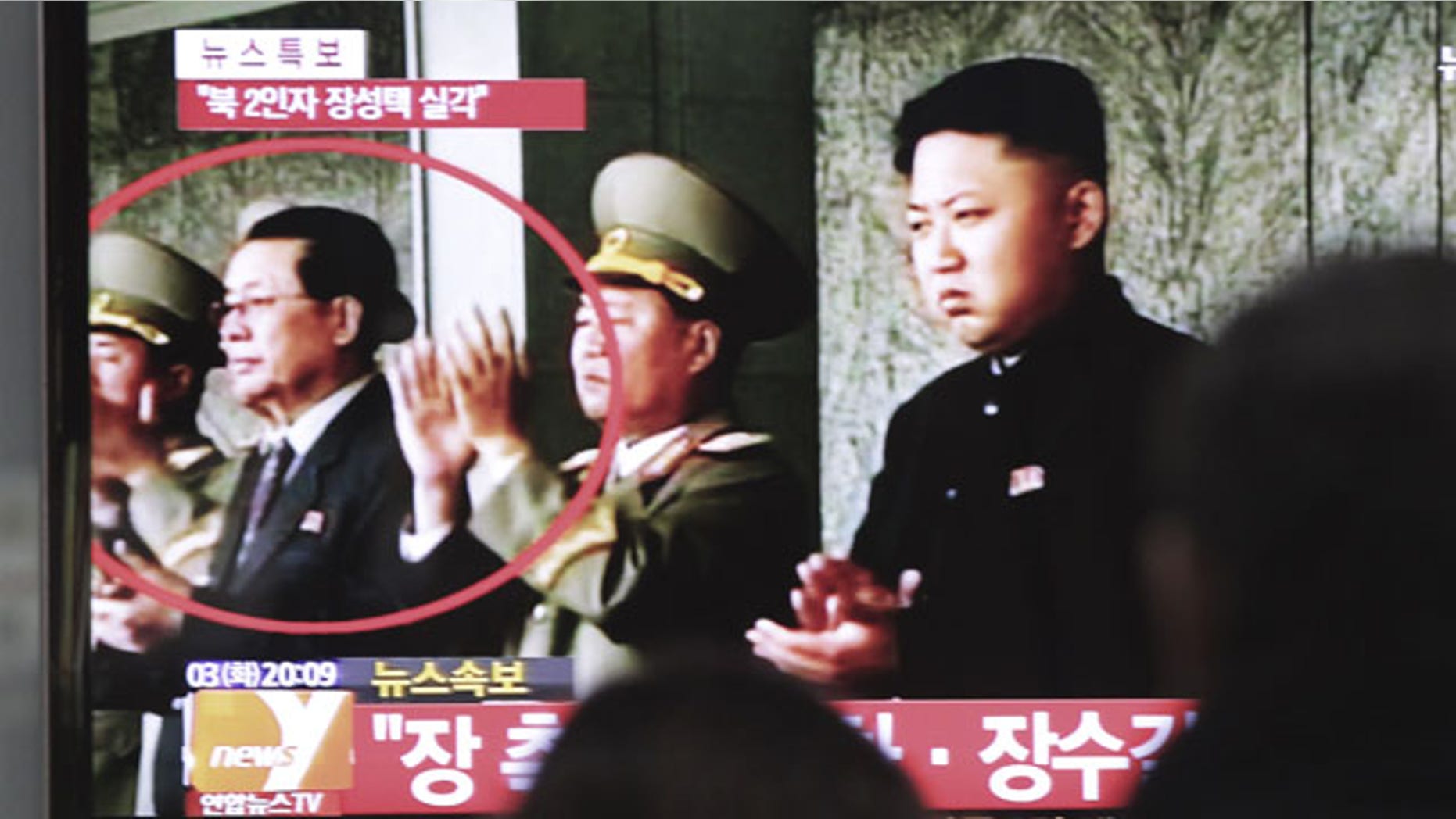 December 3, 2013: People watch a TV news program showing North Korean leader Kim Jong Un, right, and Kim's uncle, Jang Song Thaek, second from left, at the Seoul Railway Station in Seoul, South Korea. (AP Photo)