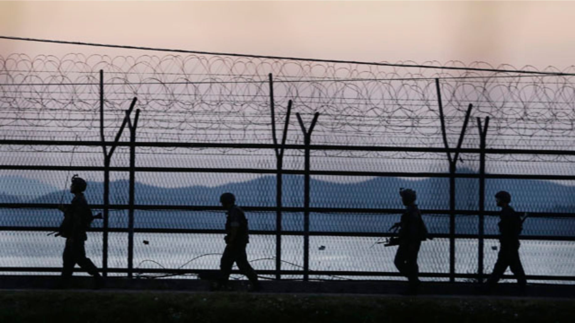 October 7, 2014: South Korean army soldiers patrol through the wire fences near the demilitarized zone between the two Koreas in Paju, South Korea. (AP Photo/Ahn Young-joon)