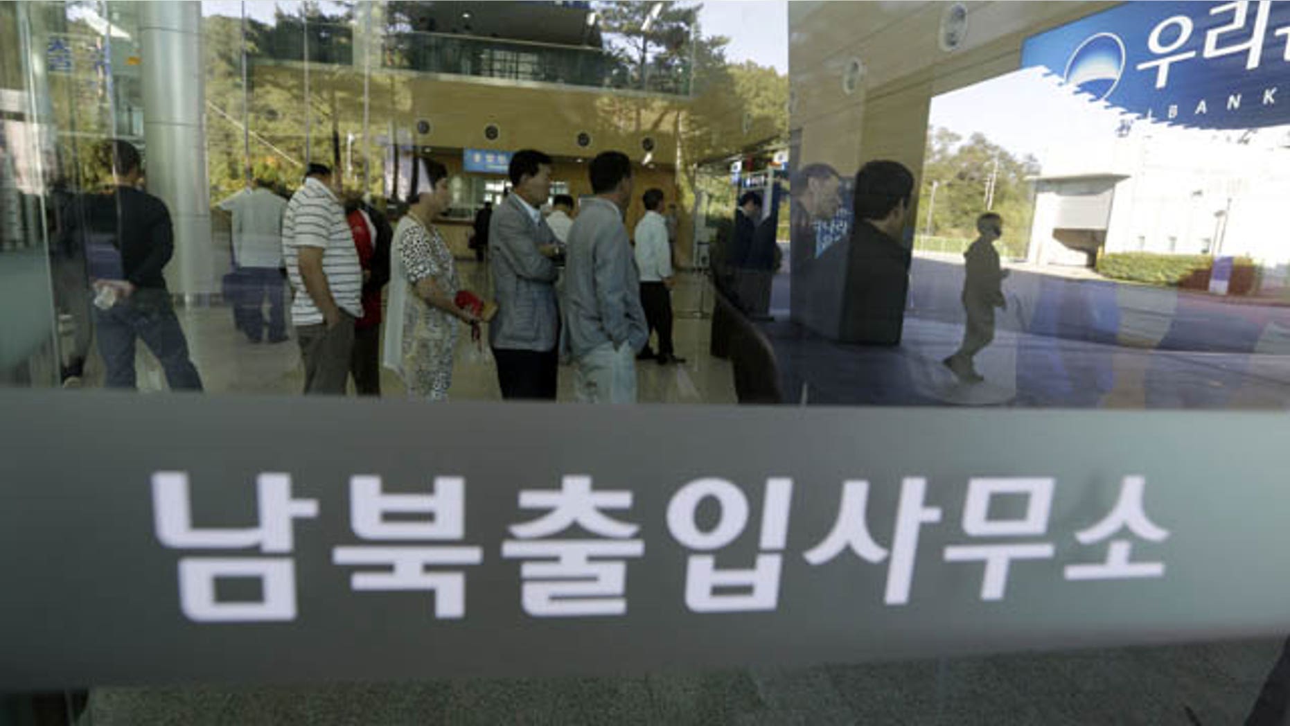 September 16, 2013: South Koreans wait in line to exchange money in front of a bank before leaving for the Kaesong Industrial Complex at the Inter-Korean Transit Office near the border village of Panmunjom, which has separated the two Koreas since the Korean War. (AP Photo)