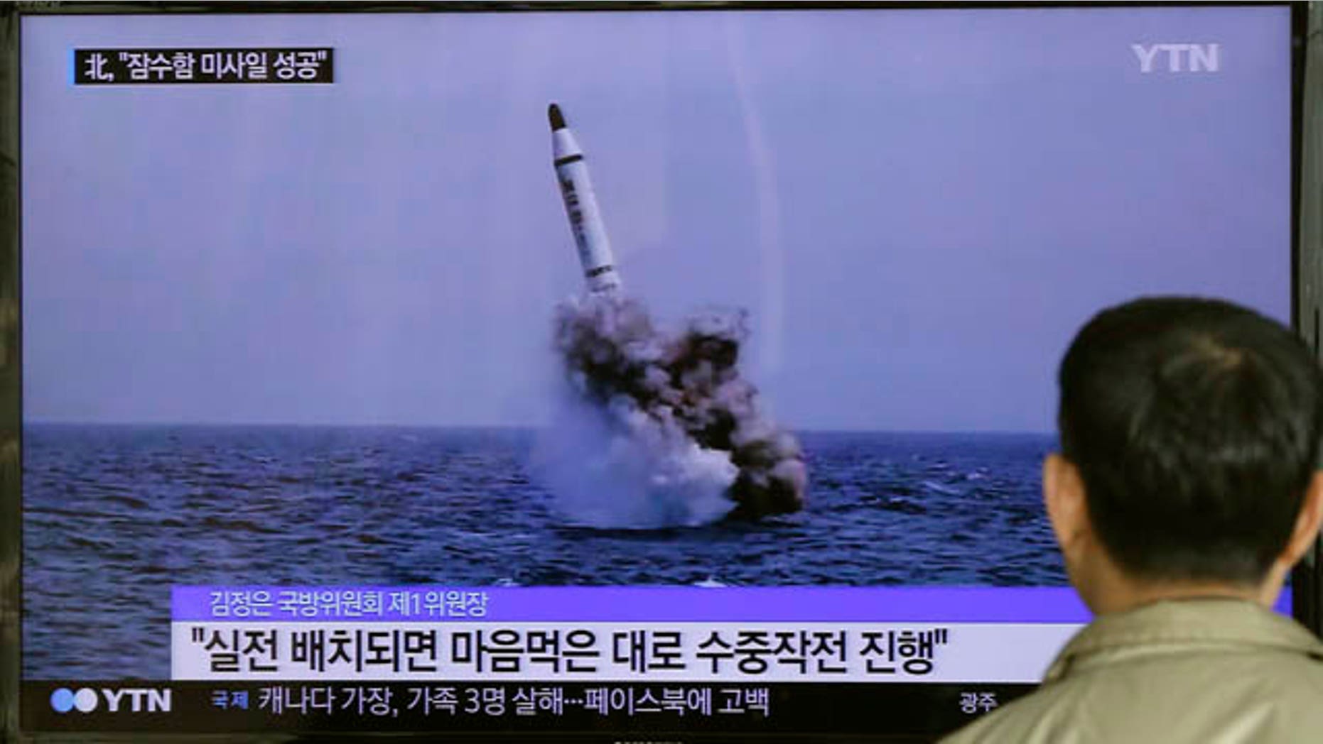 May 9, 2015: A South Korean man watches a TV news program showing an image published in North Korea's Rodong Sinmun newspaper of North Korea's ballistic missile believed to have been launched from underwater, at Seoul Railway station.(AP Photo/Ahn Young-oon)