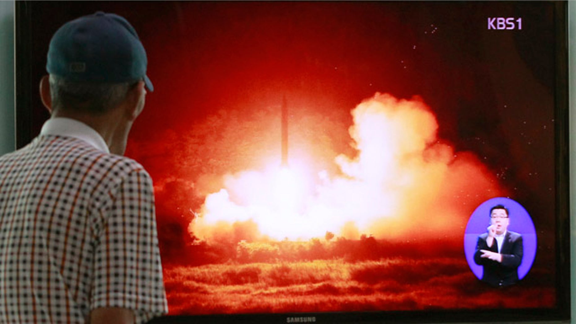 July 13, 2014: A man watches a TV news program showing a file picture of a missile launch conducted by North Korea, at Seoul Railway Station in Seoul, South Korea. (AP Photo/Ahn Young-joon)
