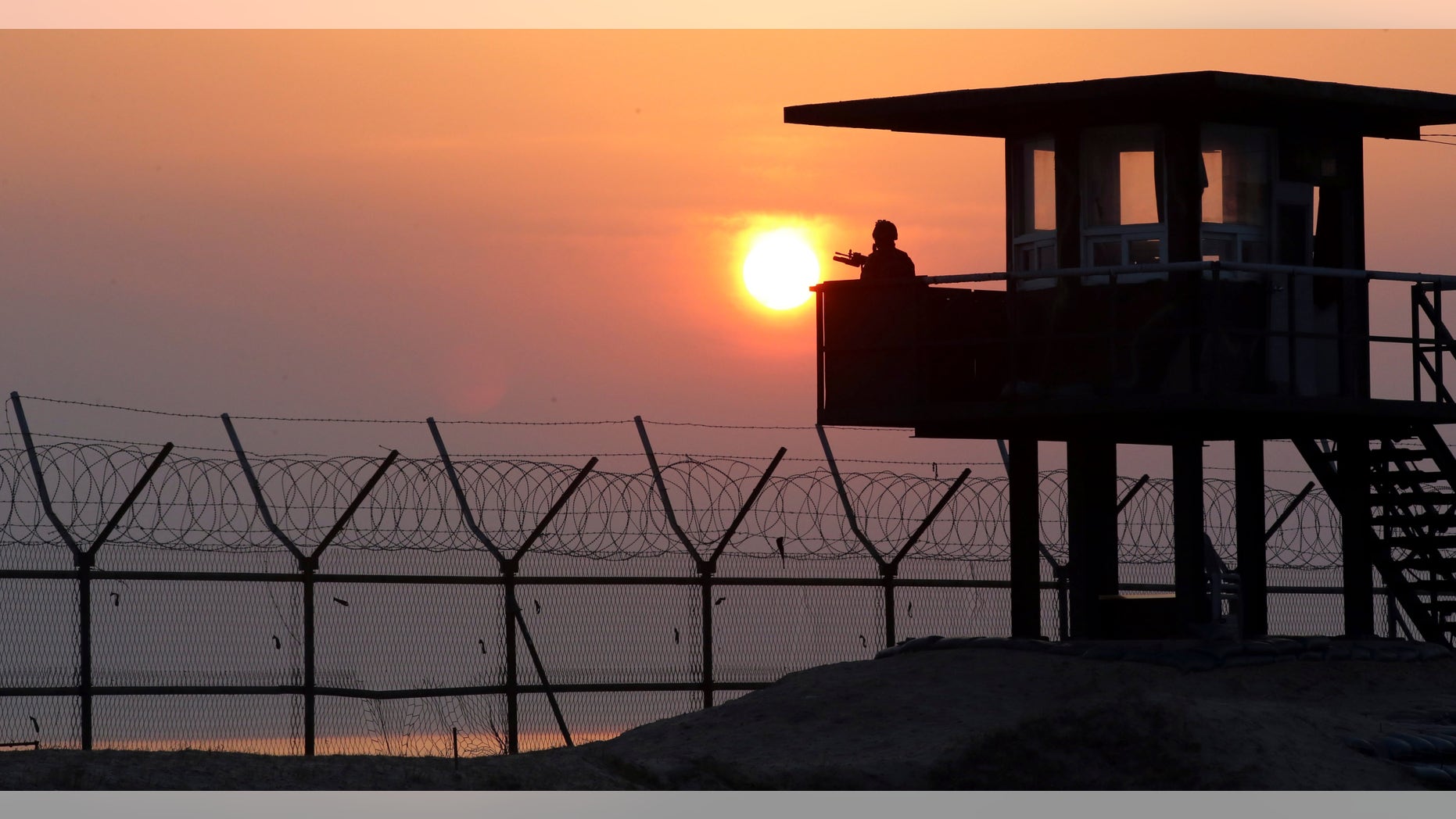 April 2, 2014 - A South Korean soldier guards with his gun at a guard post at sunrise on Baengnyeong Island, South Korea, near the West Sea border with North Korea.
