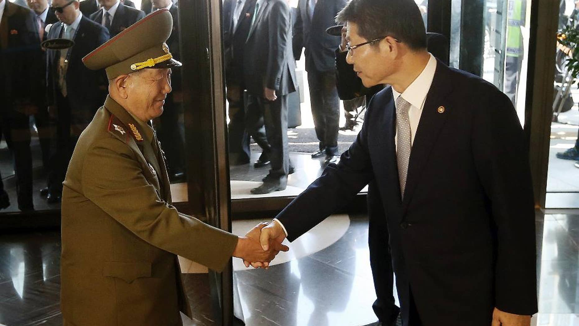 Oct. 4, 2014: Hwang Pyong So, left, vice chairman of North Korea’s National Defense Commission, shakes hands with South Korean Unification Minister Ryoo Kihl-jae upon his arrival at a hotel in Incheon, South Korea.