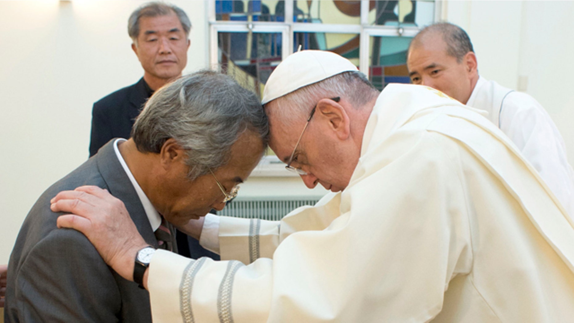 August 17, 2014: In this photo provided by the L'Osservatore Romano, Pope Francis baptizes Lee Ho Jin, the father of one of the children who died in South Korea's April ferry disaster, in Seoul. (AP Photo/L'Osservatore Romano)