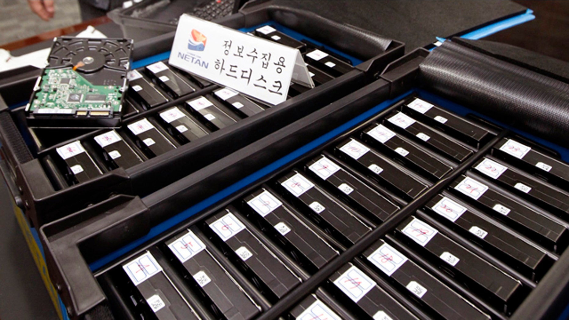 South Korean officials from the National Police Agency's Cyber Terror Response Center show some of the hard disks taken from the office of Google Korea at the headquarter of the National Police Agency in Seoul, South Korea. Google has been accused of collecting e-mails and other personal information from unsecured wireless networks while it took photos of neighborhoods in South Korea for its "Street View" mapping service.