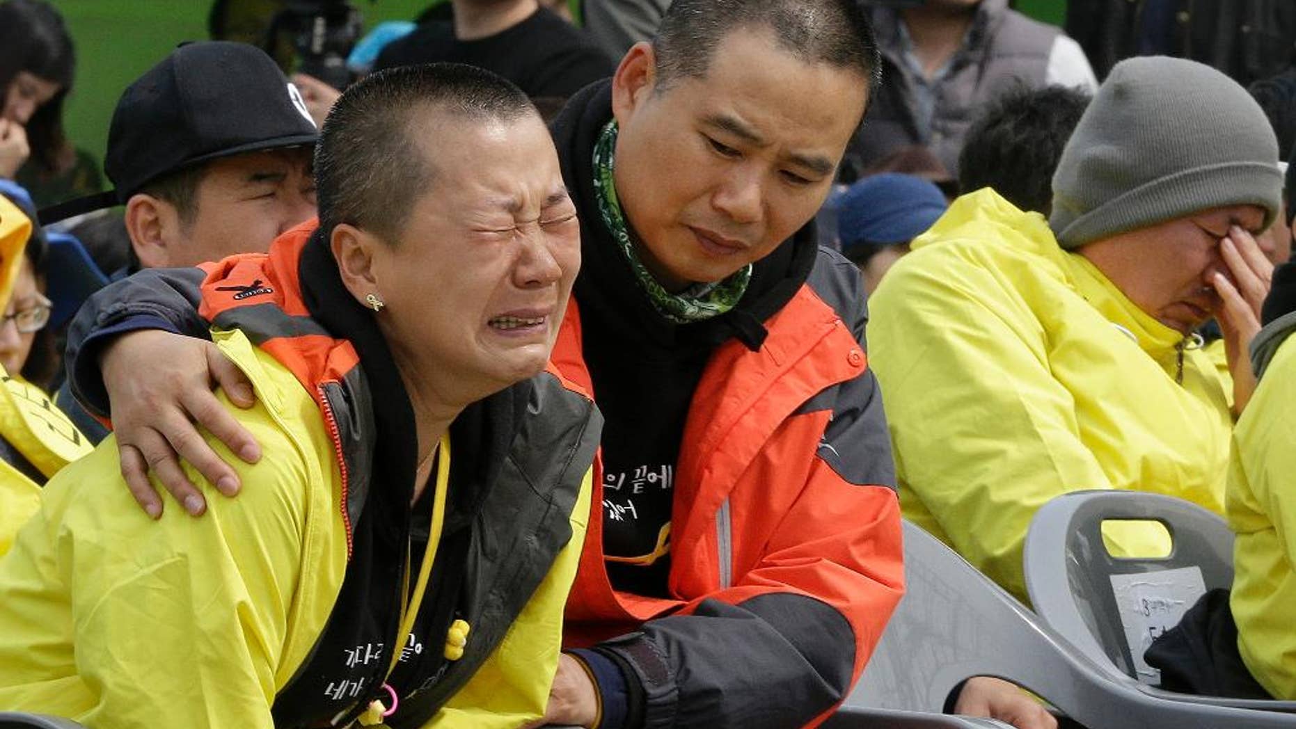A relative of the victims of the Sewol disaster weeps during a ceremony on the eve of the first anniversary of the ferry sinking at a port in Jindo, South Korea, Wednesday, April 15, 2015. A year ago, as South Korea writhed in grief and fury after more than 300 people, most of them school kids, drowned in the disaster, it seemed things would never be the same. Yet not much has really changed as the first anniversary of the Sewol disaster is marked Thursday. (AP Photo/Ahn Young-joon)