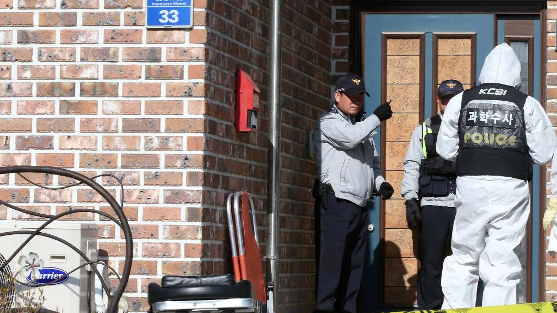 South Korean police officers investigate the scene of an incident in Hwaseong, South Korea, Friday, Feb. 27, 2015. A gunman shot and killed three people Friday before he was found dead at a home in a city near the capital Seoul in the second such incident in three days, police officials said. (AP Photo/Yonhap, Shin Young-gun) KOREA OUT