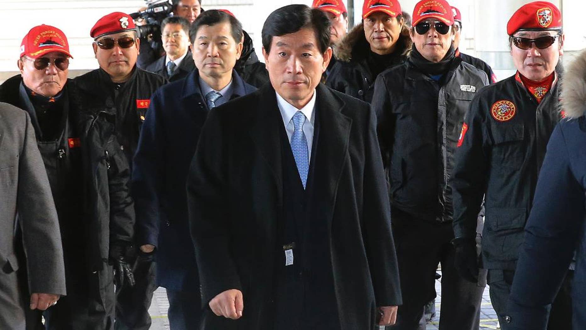 Former National Intelligence Service director Won Sei-hoon, center, arrives at the Seoul High Court in Seoul, South Korea, Monday, Feb. 9, 2015. Won headed to prison after being found guilty of ordering an illicit online campaign to support then-ruling party candidate and current President Park Geun-hye ahead of the 2012 presidential election. (AP Photo/Yonhap) KOREA OUT