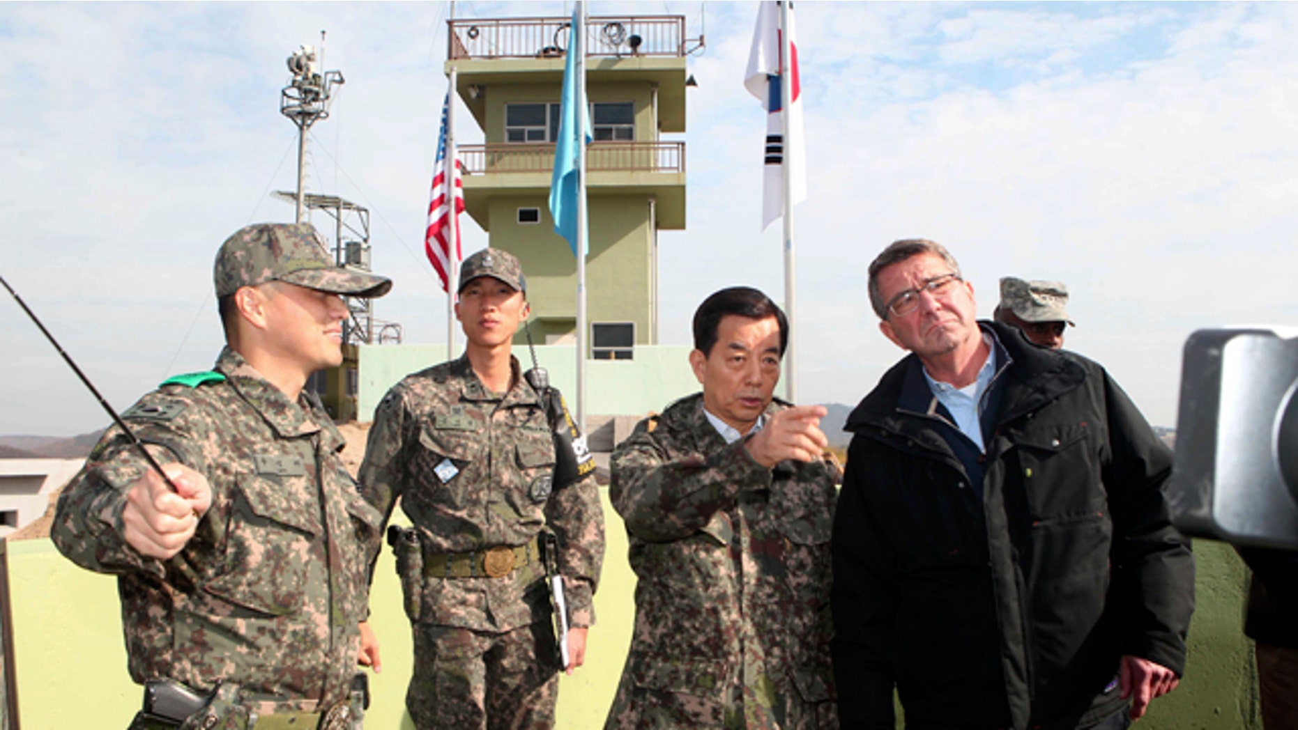 Nov. 1, 2015: U.S. Defense Secretary Ash Carter, right, and South Korean Defense Minister Han Min Koo, second from right, look towards North Korea at an observation post near the border village of Panmunjom, which has separated the two Koreas since the Korean War. (Korea Pool Photo via AP)