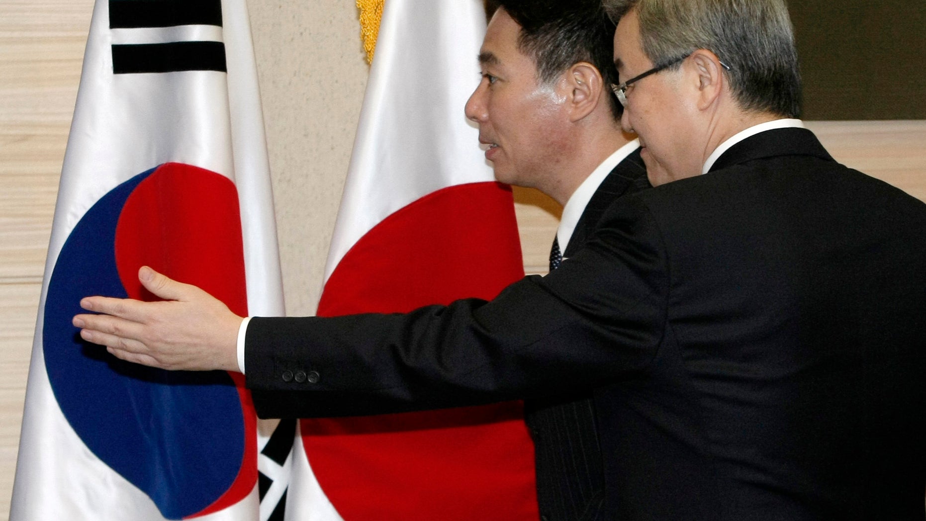 Japanese Foreign Minister Seiji Maehara, back, is escorted by South Korean counterpart Kim Sung-hwan as they arrive to hold their joint press conference at the Ministry of Foreign Affairs and Trade in Seoul, South Korea, Saturday, Jan. 15, 2011. The top diplomats of South Korea and Japan are continuing their hard line on North Korea's push for aid-for-nuclear disarmament talks.