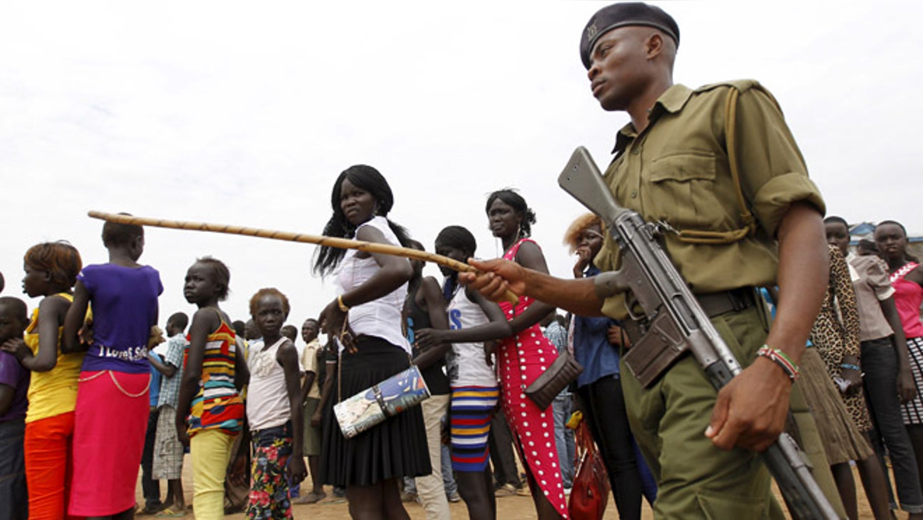 June 20, 2015: A policeman patrols as refugees from South Sudan queue to attend the celebrations to mark World Refugee Day.