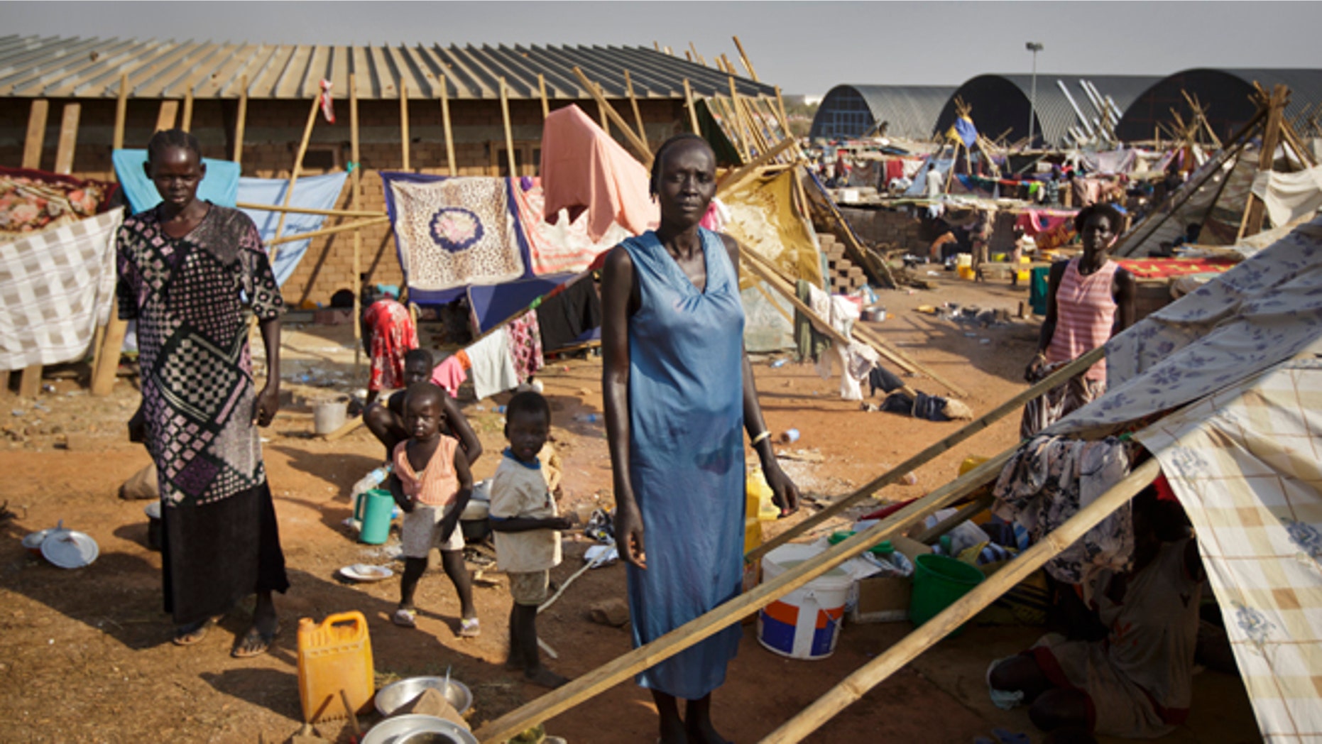 Dec. 31: A displaced family stand by their makeshift shelter at a United Nations compound which has become home to thousands of people displaced by the recent fighting, in the Jebel area on the outskirts of Juba, South Sudan.