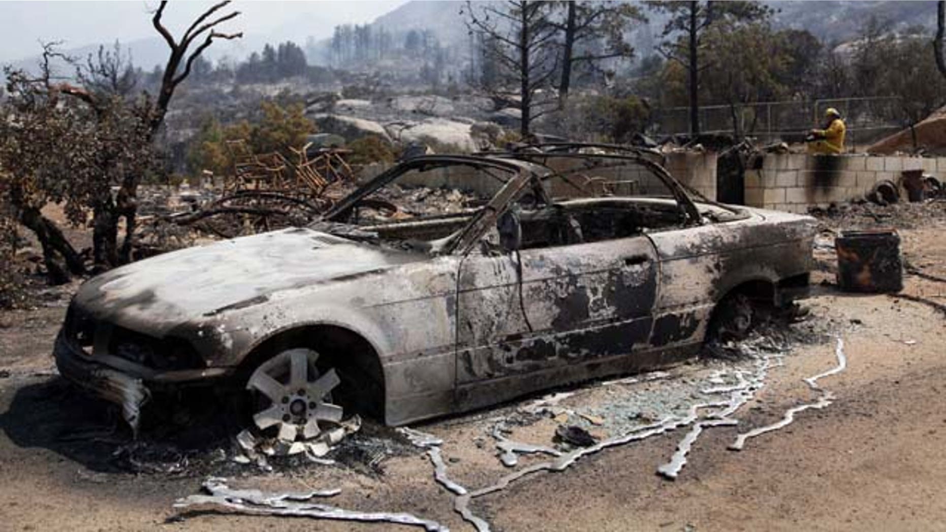 July 18, 2013: The charred remains of a car are shown after a wildfire passed through the area of Lake Hemet, Calif. (AP Photo/Nick Ut)