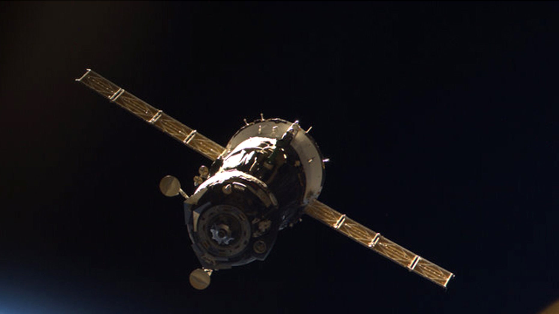 The Russian-built Soyuz TMA-16 spacecraft, as photographed from the inside of the space station by Japanese astronaut Soichi Noguchi, after the ship undocked March 18, 2010.