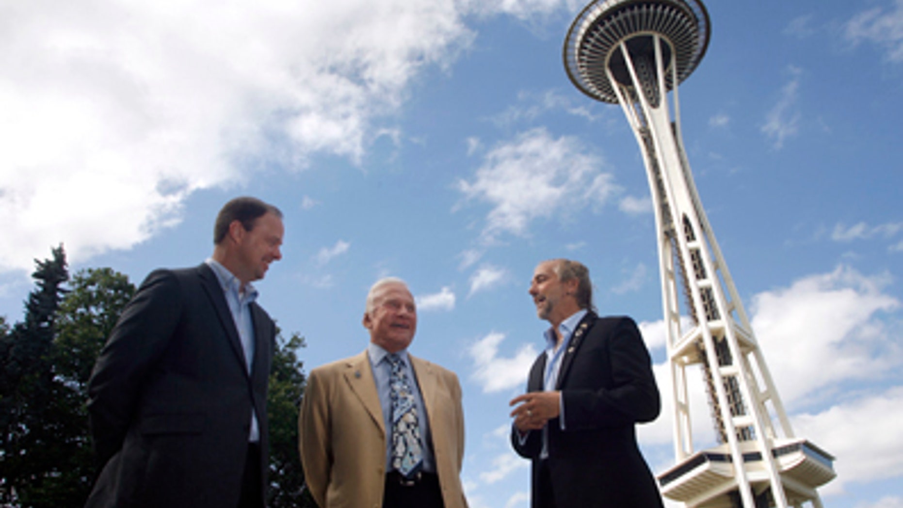 Buzz Aldrin, former astronaut, center, and Richard Garriott, first second-generation space traveler, right, talk about space exploration outside the Space Needle on Sunday, July 31, 2011, in Seattle as Ron Sevart, CEO of the Space Needle, left, listens in. Aldrin and Garriott were at the Space Needle to help promote a contest sponsored by the Needle to celebrate its 50th anniversary by sending a member of the general public into space. (AP Photo/Joe Nicholson)