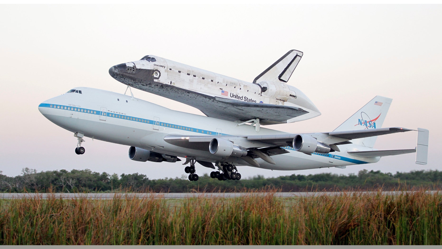 Space shuttle Discovery atop a 747 carrier jet departs the Kennedy Space Center, Tuesday, April 17, 2012, in Cape Canaveral, Fla. Discovery is being transported to the Smithsonian National Air and Space Museum in Washington. (AP Photo/John Raoux)