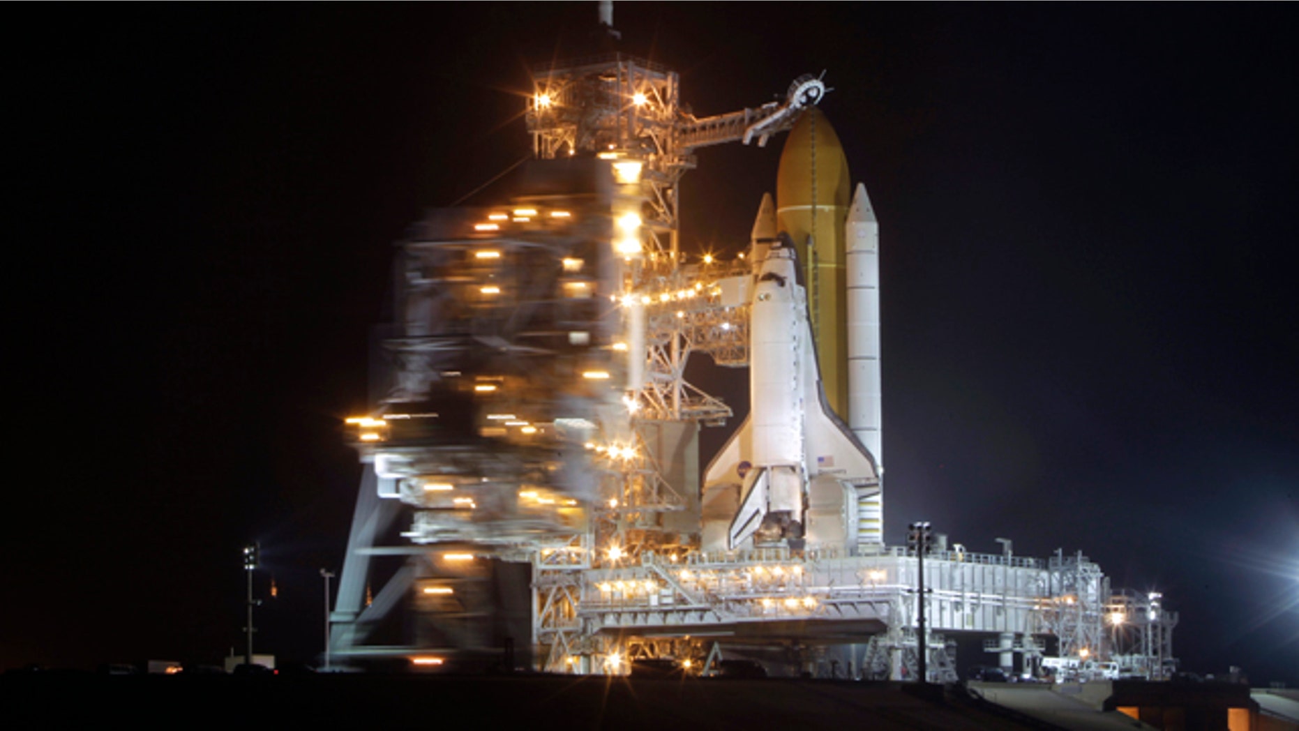 Space shuttle Discovery stands ready for launch at Pad 39A as the rotating service structure is moved back to expose the orbiter at the Kennedy Space Center in Cape Canaveral, Fla., Wednesday, Feb. 23, 2011.