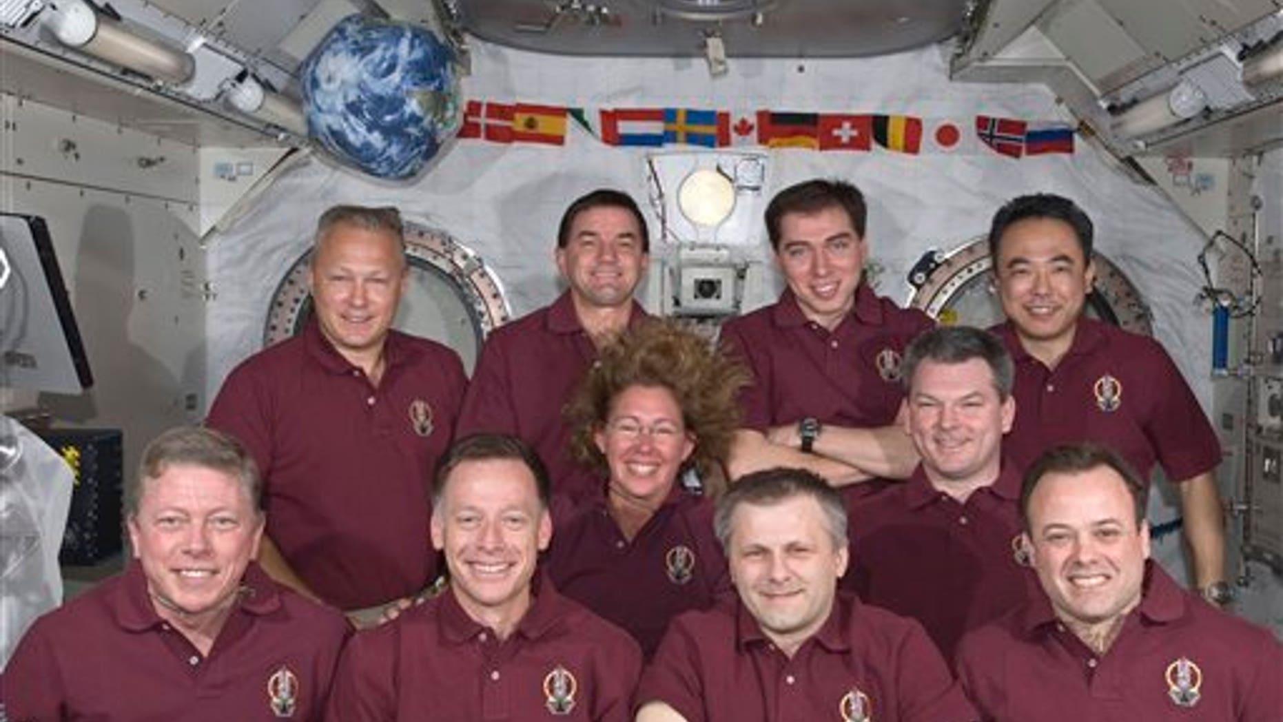 July 17: In this image provided by NASA the Expedition 28 crew and the STS-135 Atlantis astronauts take a break from a busy day in space to pose for a portrait aboard the orbiting complex's Kibo laboratory of the Japan Aerospace Exploration Agency. Left to right in the front row are Mike Fossum, Chris Ferguson, Andrey Borisenko and Ron Garan; in the middle row are Sandy Magnus and Alexander Samokutyaev; and the back row consists of Doug Hurley, Rex Walheim, Sergi Volkov and JAXA astronaut Satoshi Furukawa.