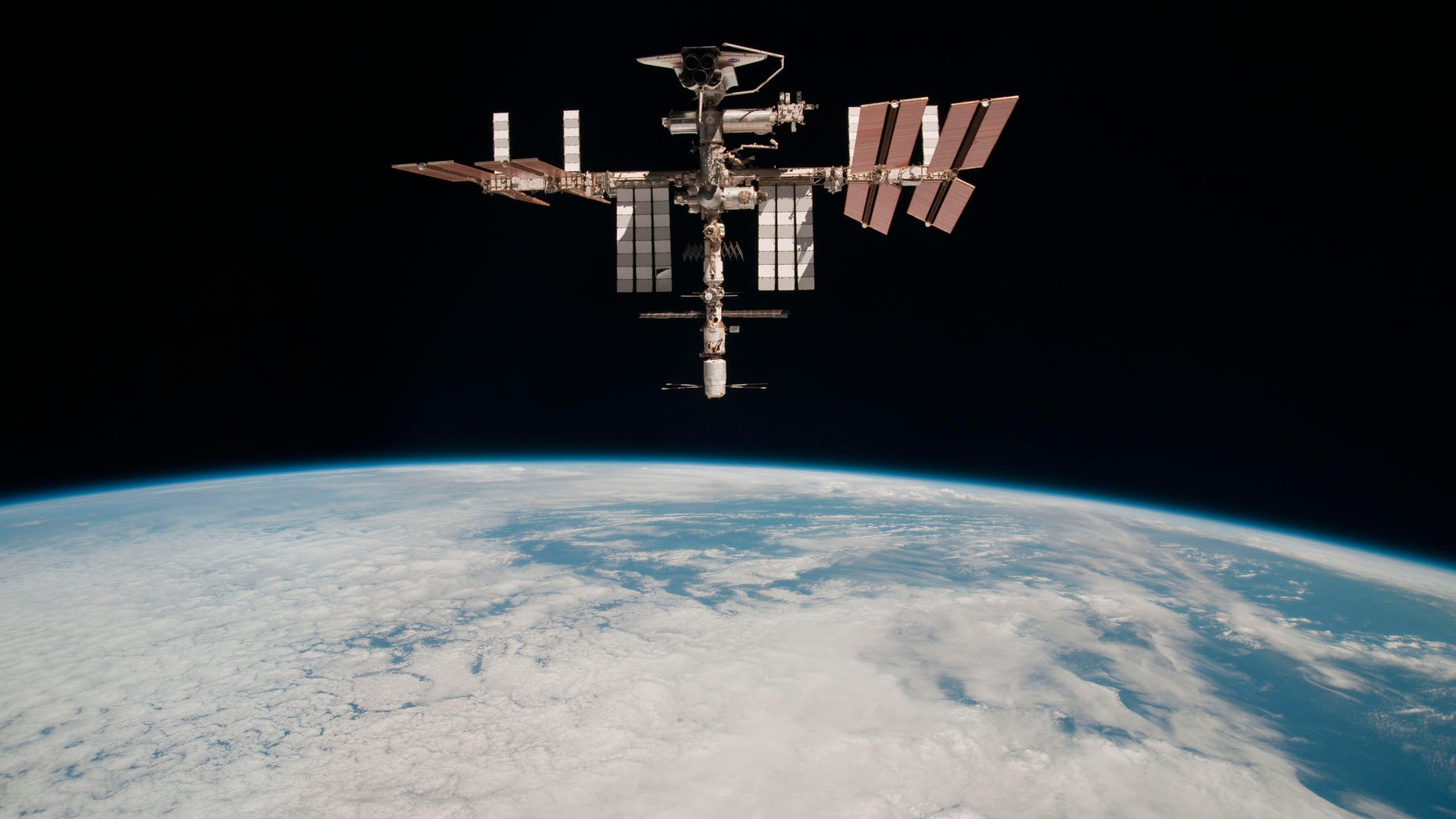 This May 23, 2011 photo released by NASA shows the International Space Station at an altitude of approximately 220 miles above the Earth, taken by Expedition 27 crew member Paolo Nespoli from the Soyuz TMA-20 following its undocking.