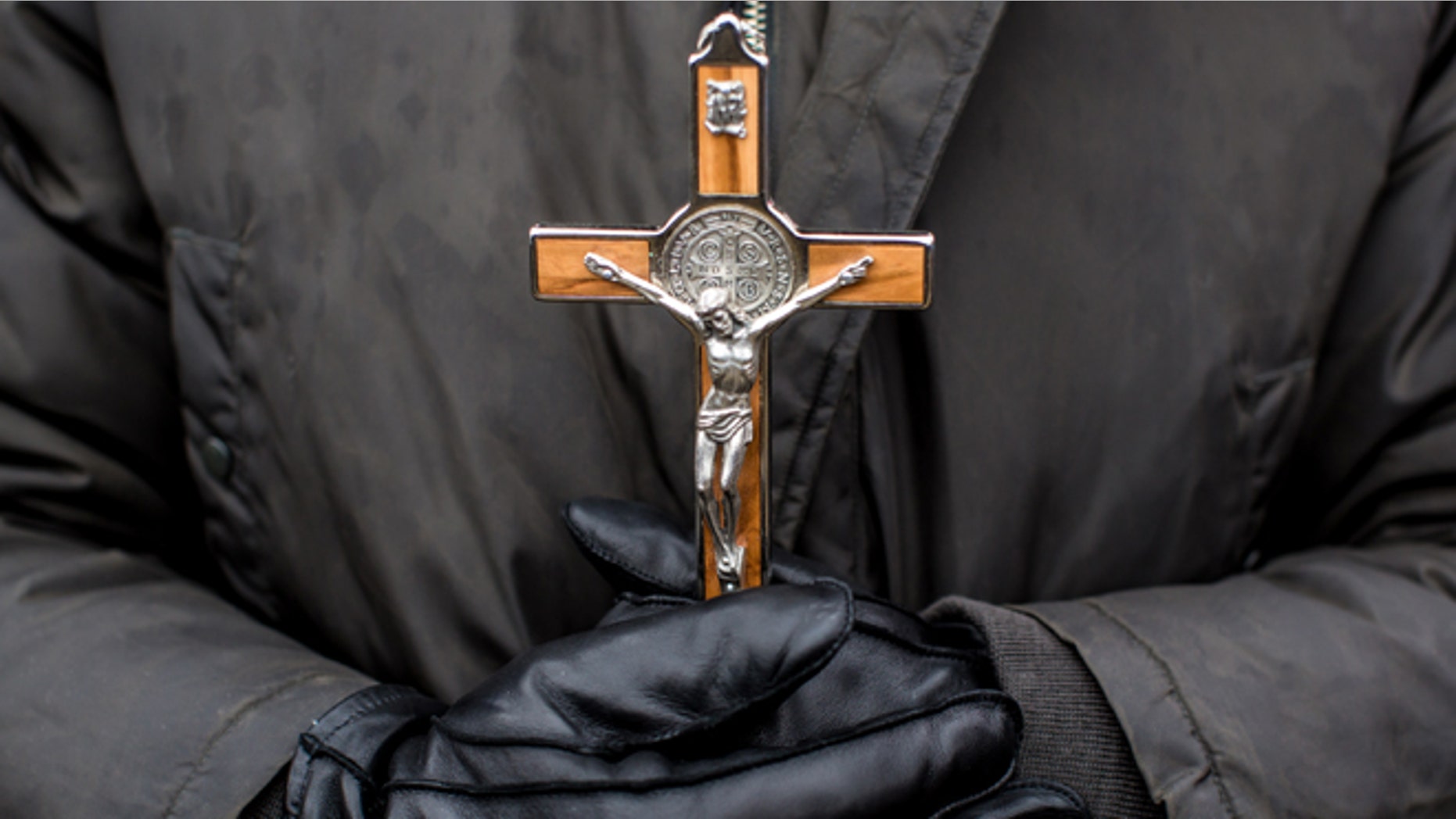 WASHINGTON, DC - JANUARY 25: An anti-abortion protester holds a crucifix at the March for Life on January 25, 2013 in Washington, DC. The pro-life gathering is held each year around the anniversary of the Roe v. Wade Supreme Court decision. (Photo by Brendan Hoffman/Getty Images)