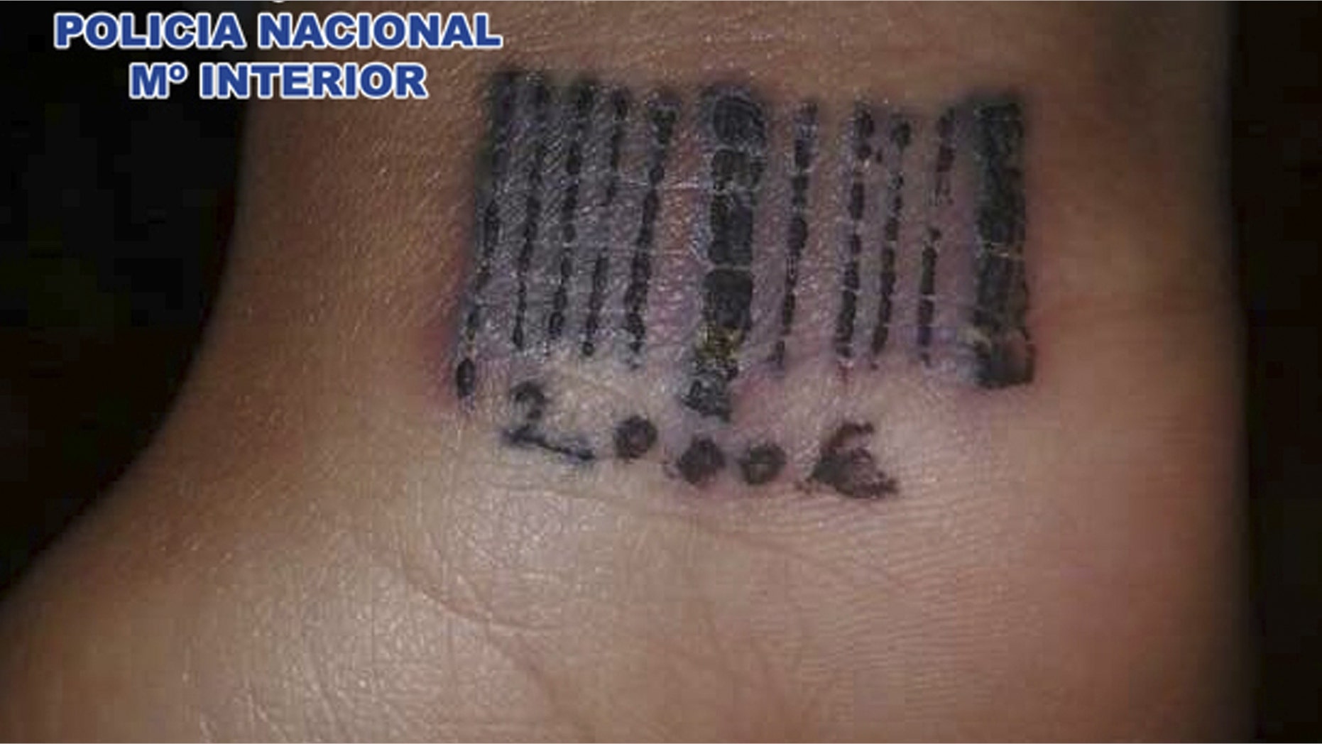 In this photo released by the Spanish Police on Saturday March 24, 2012 a tattoo in the form of a bar code is seen on the wrist of a woman in this hand out photo. Spain´s Interior Ministry says police have arrested 22 persons of Romanian nationality on suspicion of using violence to force women into prostitution and tattooing them with bar codes as a sign of ownership. Officers freed one 19-year-old woman who had been beaten, held against her will and tattooed with a bar code and an amount of money which investigators believe was the debt the gang wished to extort before freeing her. The women were tattooed on their wrists, and the freed woman had the sum 2,000 euro ($ 2,650) etched onto her skin. (AP Photo/Spanish Police)