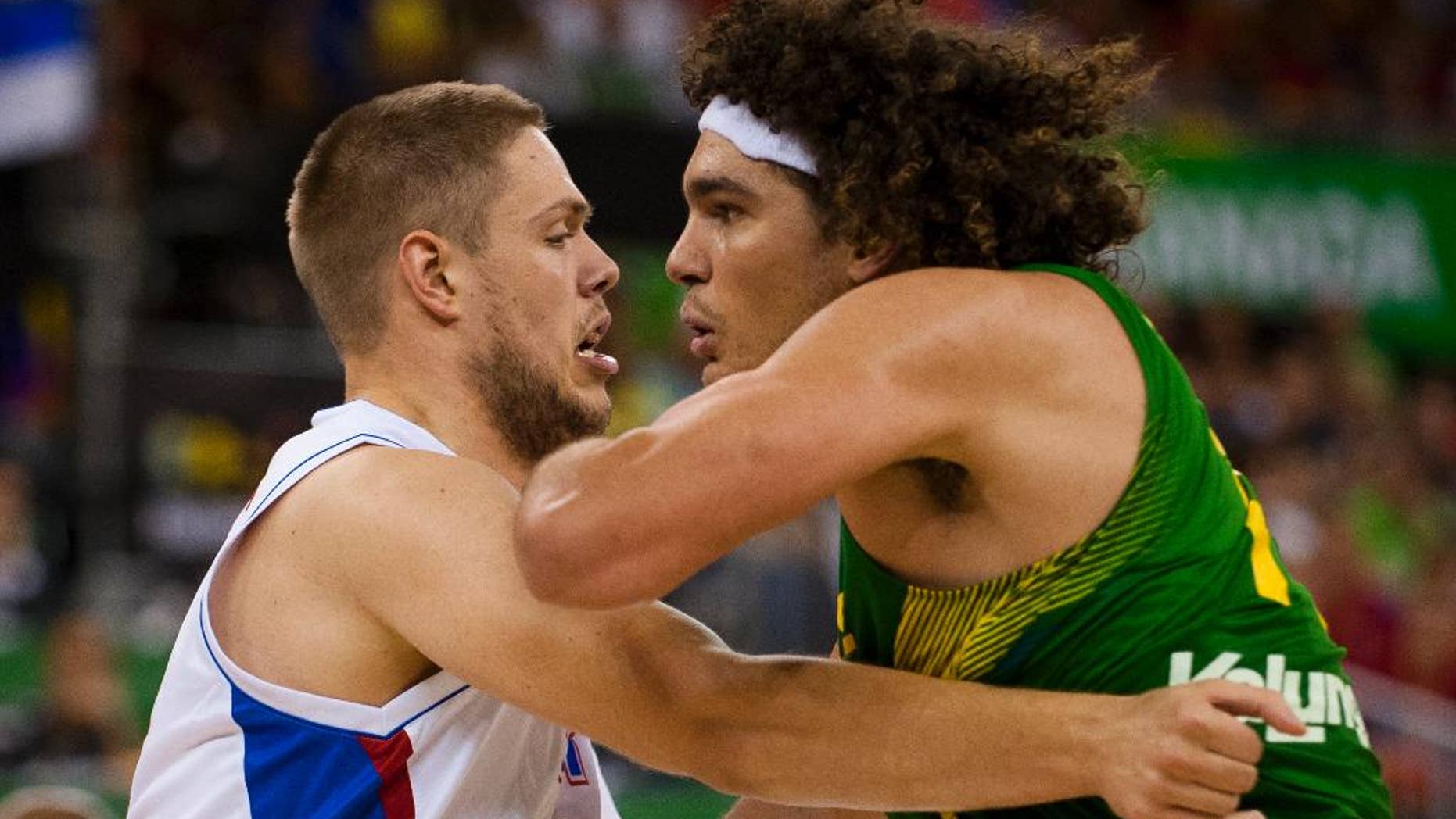 Brazil's Nene Hilario, right, fights for position with Serbia's Vladimir Stimac during the Group A Basketball World Cup match in Granada, Spain, Wednesday, Sept. 3, 2014. The 2014 Basketball World Cup competition will take place in various cities in Spain from Aug. 30 through to Sept. 14. (AP Photo/Daniel Tejedor)