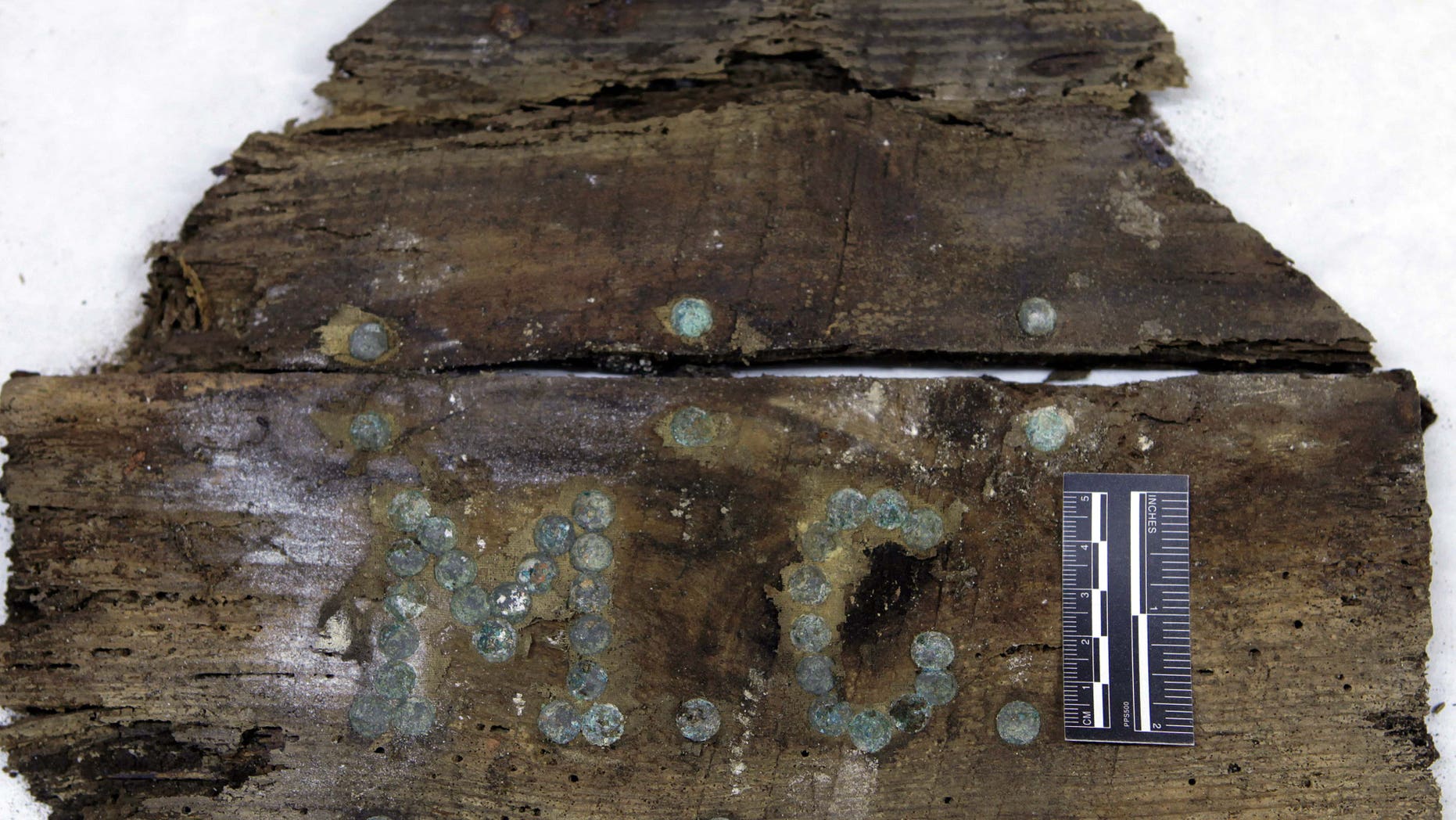 In this photo taken on Saturday, Jan. 24, 2015 and provided by Aranzadi Science Society, the initials "M.C" are seen on a plank of a coffin found on unidentified graves in the chapelâs crypt of the closed order Convent of the Barefoot Trinitarians in Madrid's historic Barrio de las Letras, or Literary Quarter. Experts searching for the remains of Miguel de Cervantes, the author of 'Don Quixote' who was buried in 1616 at the Convent but the exact whereabouts of his grave are unknown, have found a casket bearing the initials âM.C.â with bones inside it in crypt underneath a cloistered convent. Archeologists say they made the find over the weekend after excavations to solve the centuries-old mystery of where the great Spanish writer was laid to rest. (AP Photo/Aranzadi Science Society)