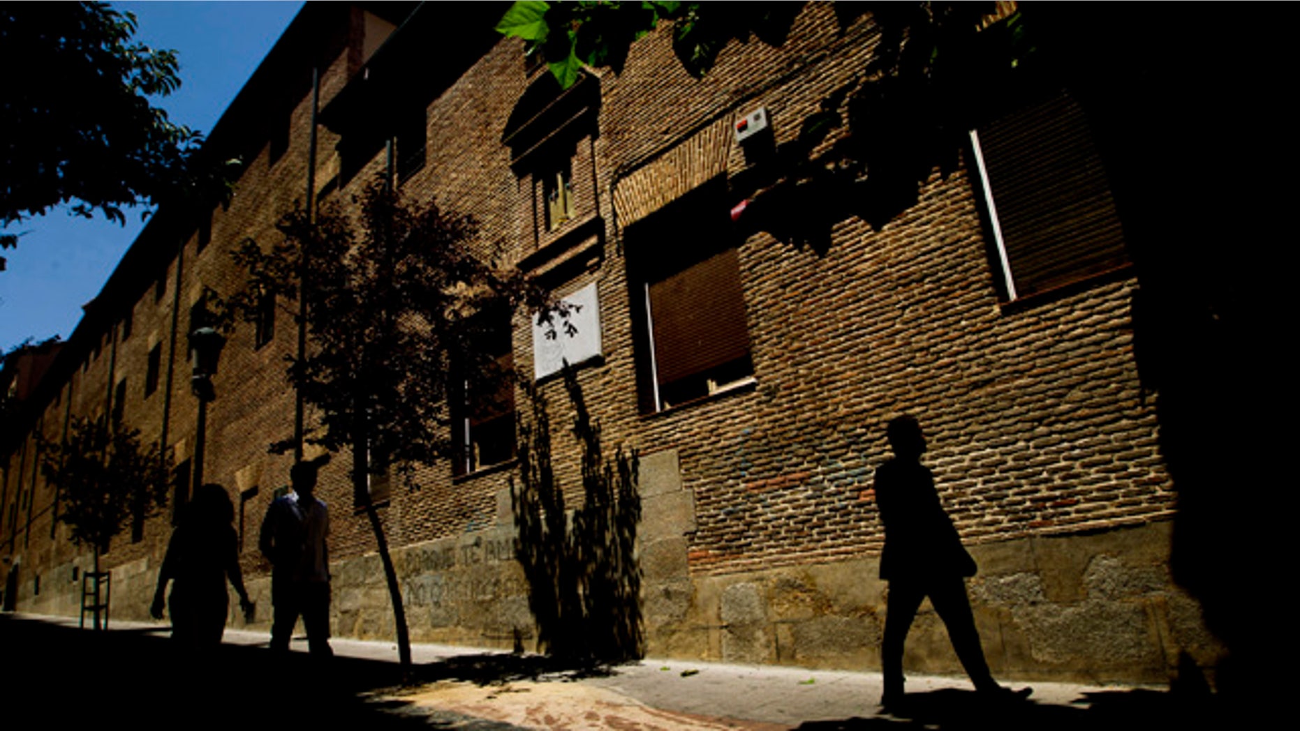FILE - In this July 28, 2011 file photo, pedestrians walk by the closed order convent of the Trinitarias Descalzas, where the Spanish writer Miguel de Cervantes, author of El Quijojte, was buried in Madrid, Spain. His coffin and remains were lost during construction work at the church. (AP Photo/Daniel Ochoa de Olza, File)