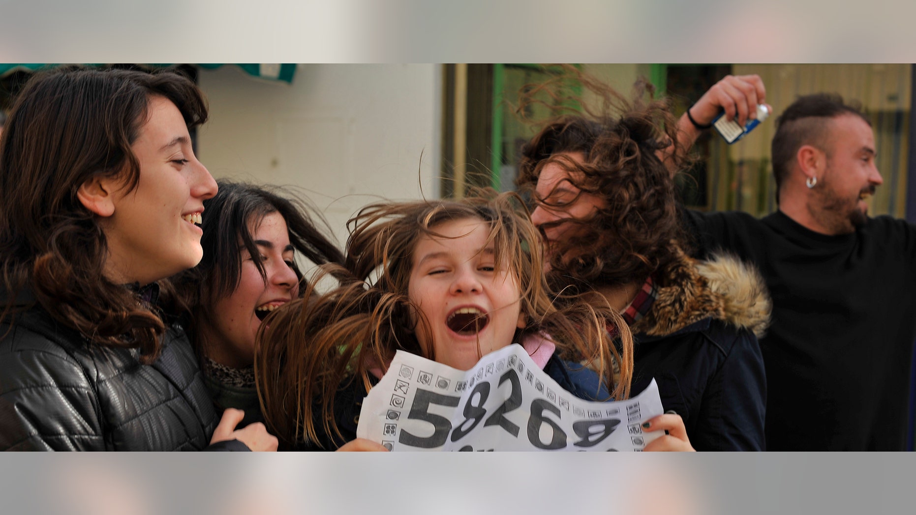 People celebrates winning a share in the top prize of Spain's Christmas lottery known as "El Gordo" or "The Fat One" with the number 58268 in the small town of Granen, northern Spain, Thursday Dec. 22, 2011, around 300 kilometers from Madrid. Economic gloom is taking a back seat in Spain as the lottery billed as the world's richest dishes out some euro 2.52 billion ($3.29 billion) to winners across the nation. The top prize of euro 720 million, dubbed "El Gordo" was split Thursday among the holders of tickets bearing the number 58268. The number appeared on 1,800 tickets. (AP Photo/Alvaro Barrientos)