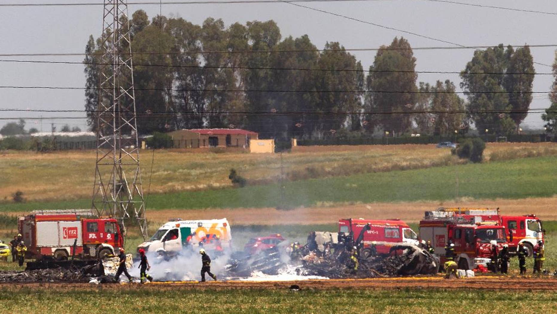 May 9, 2015: Emergency services personnel work at the scene of a plane crash near Seville airport, Seville, Spain.